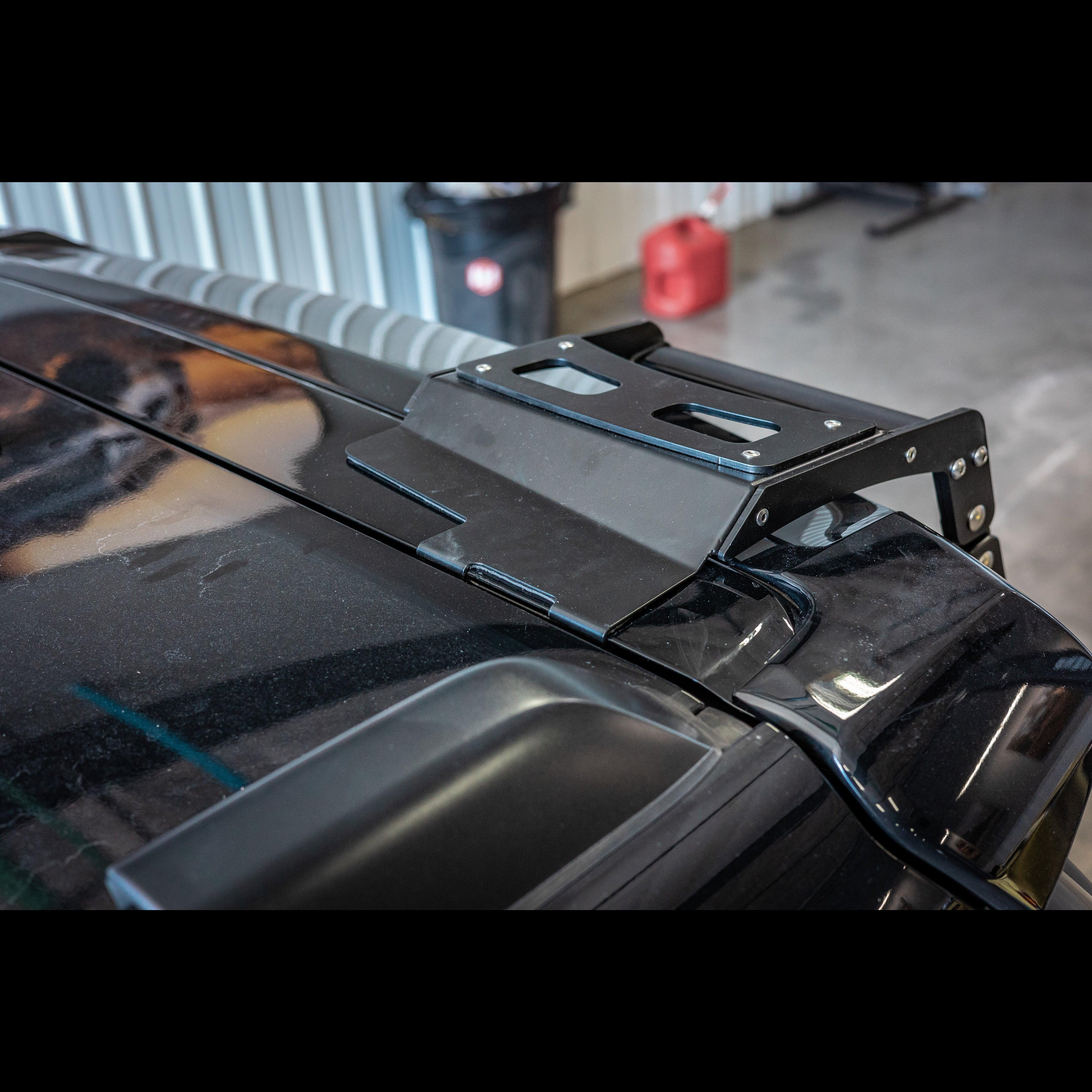 Close-up of black metal hatch ladder mount installed on Toyota 4Runner roof