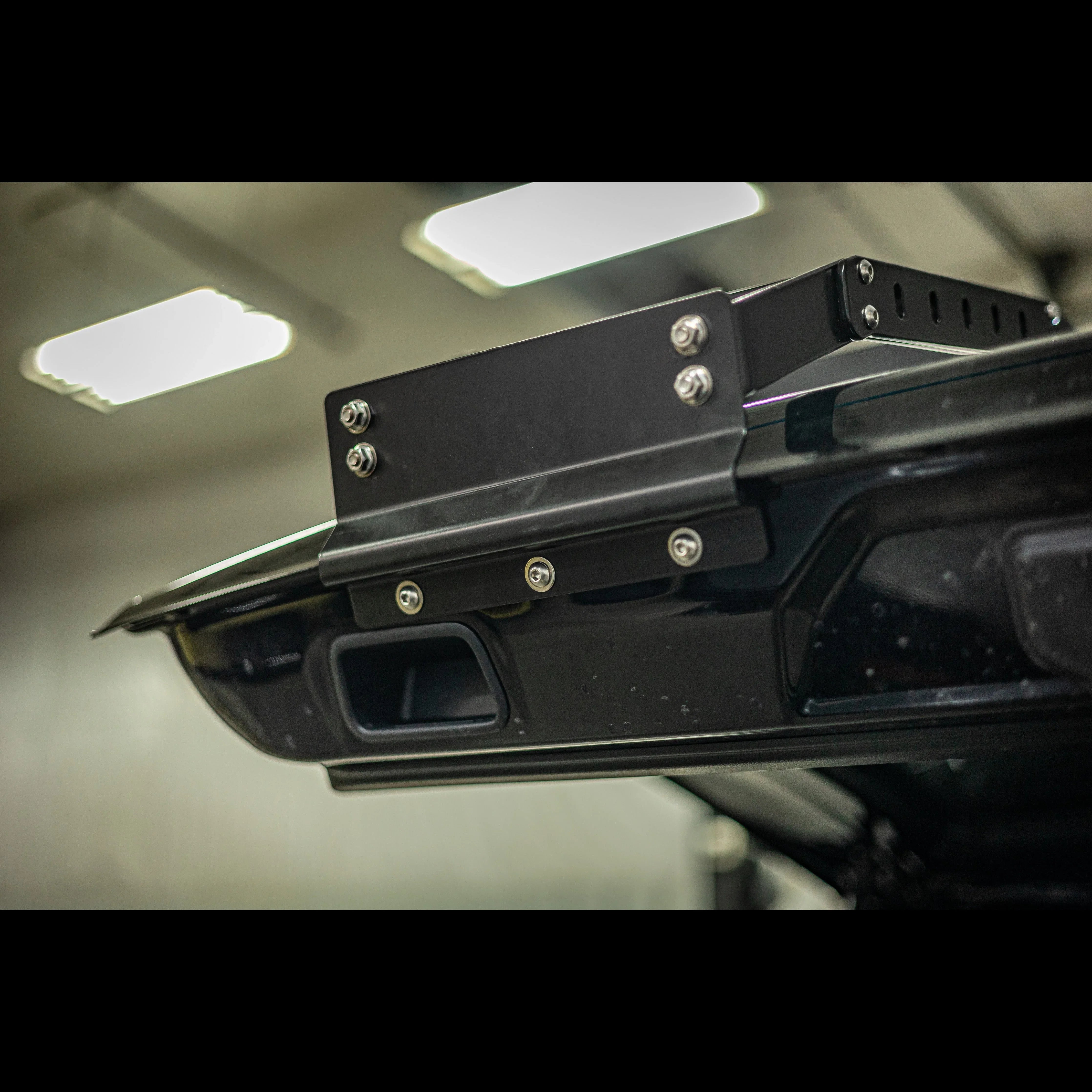 Close-up of black metal hatch ladder bracket mounted on Toyota 4Runner rear door