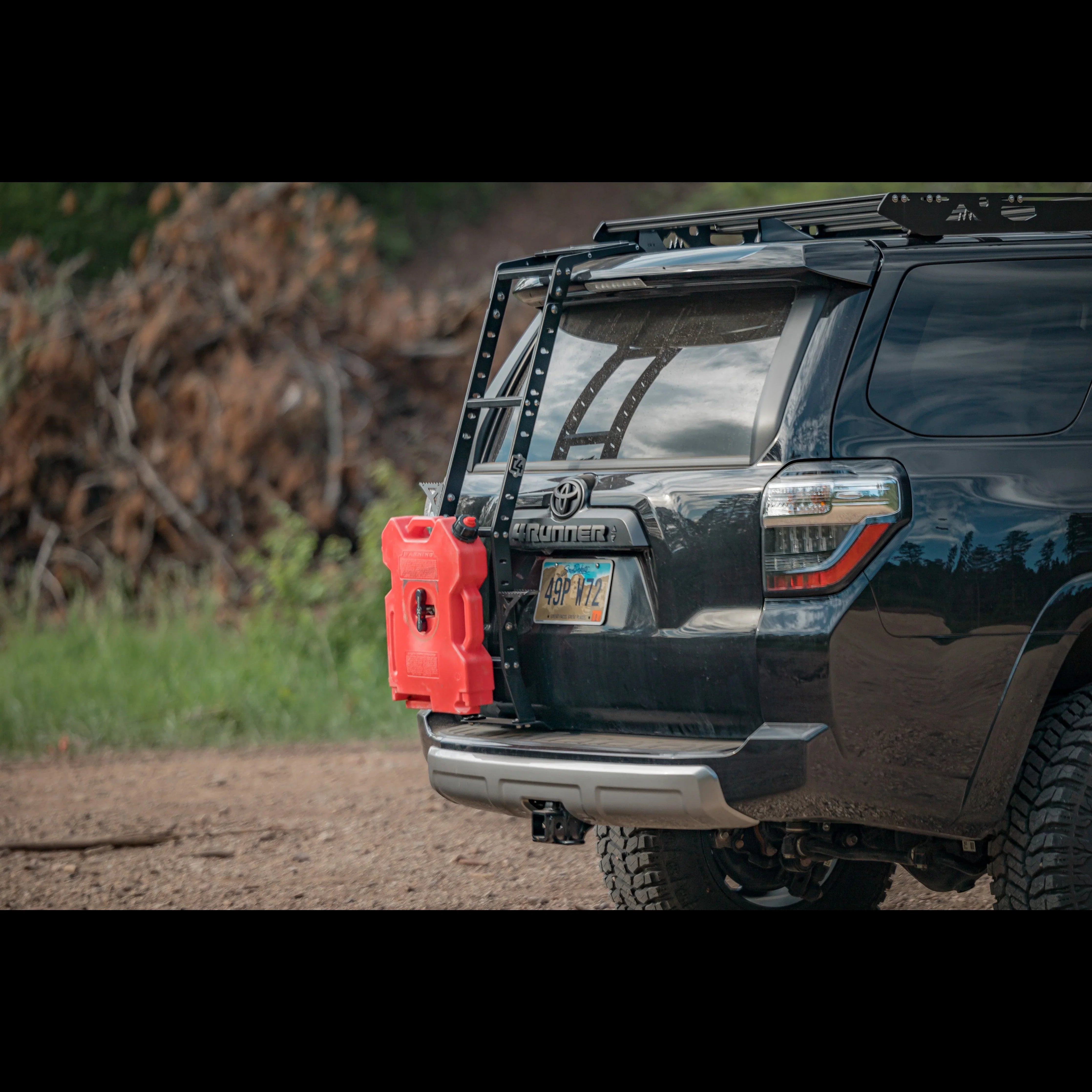 Toyota 4Runner with rear hatch ladder and red fuel canister for overlanding