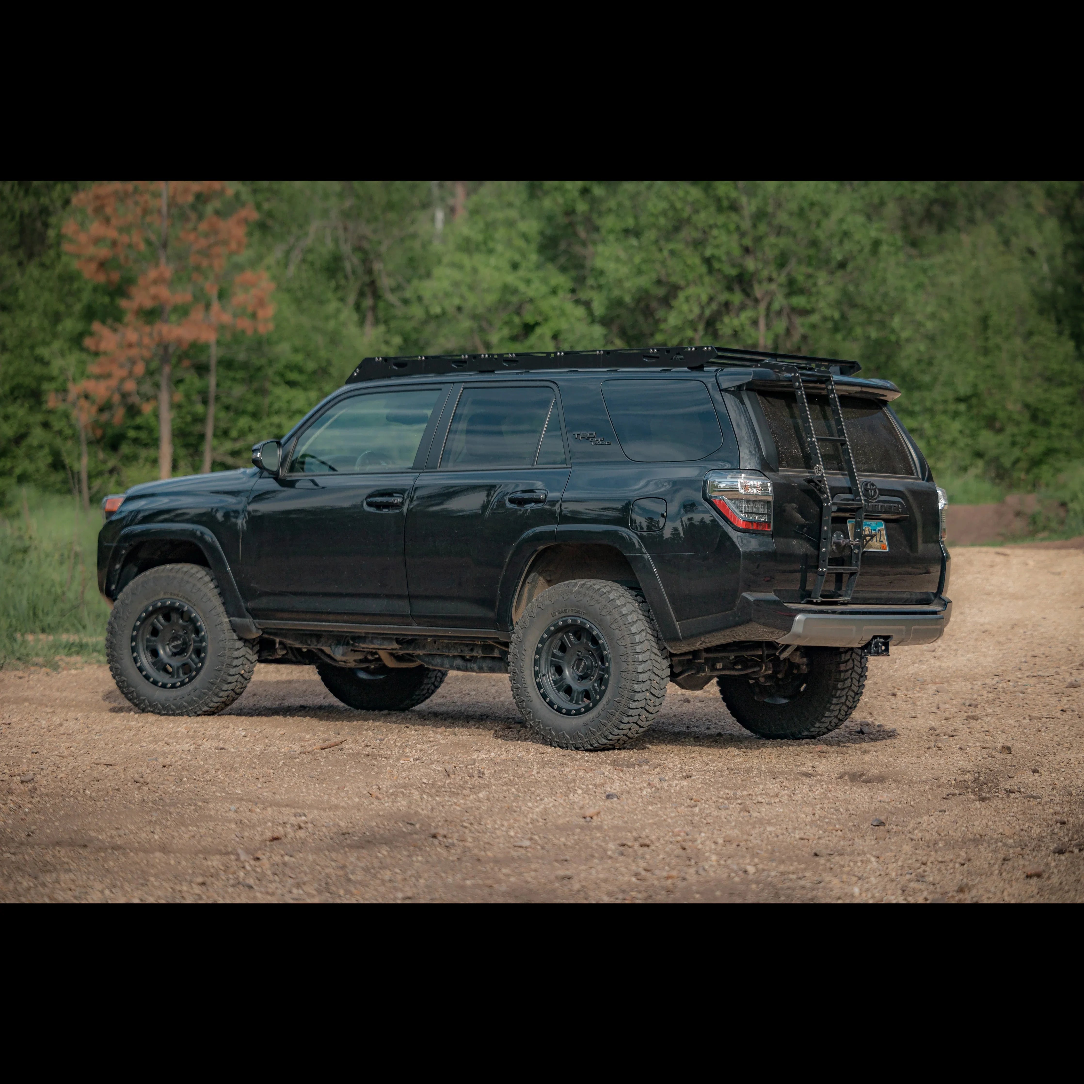 Toyota 4Runner with summit hatch ladder, off-road tires, parked outdoors