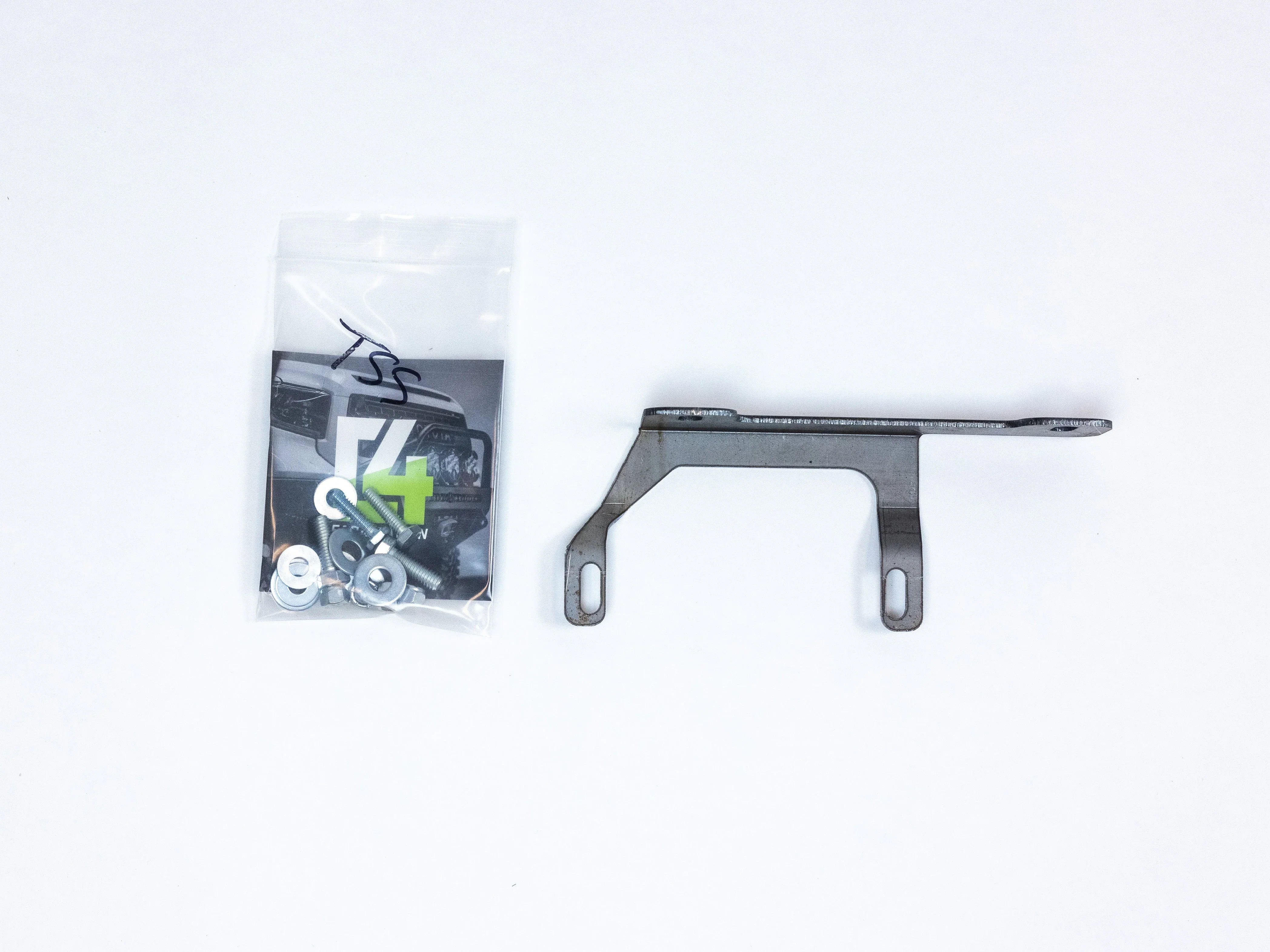 Toyota 4Runner TSS relocation bracket kit with mounting hardware on white background