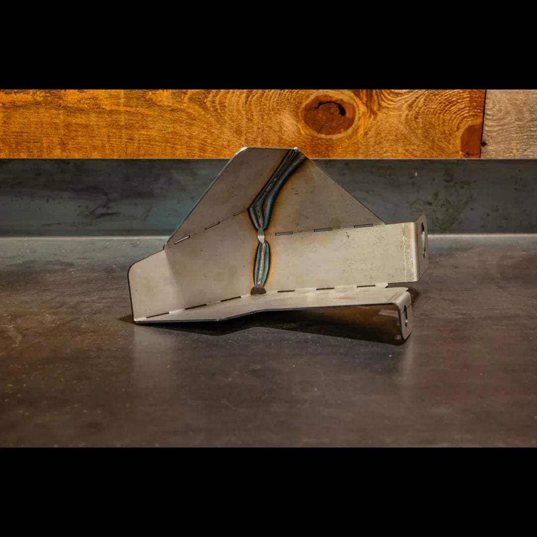 Metal skid plate for Toyota 4Runner windshield washer tank on workshop table