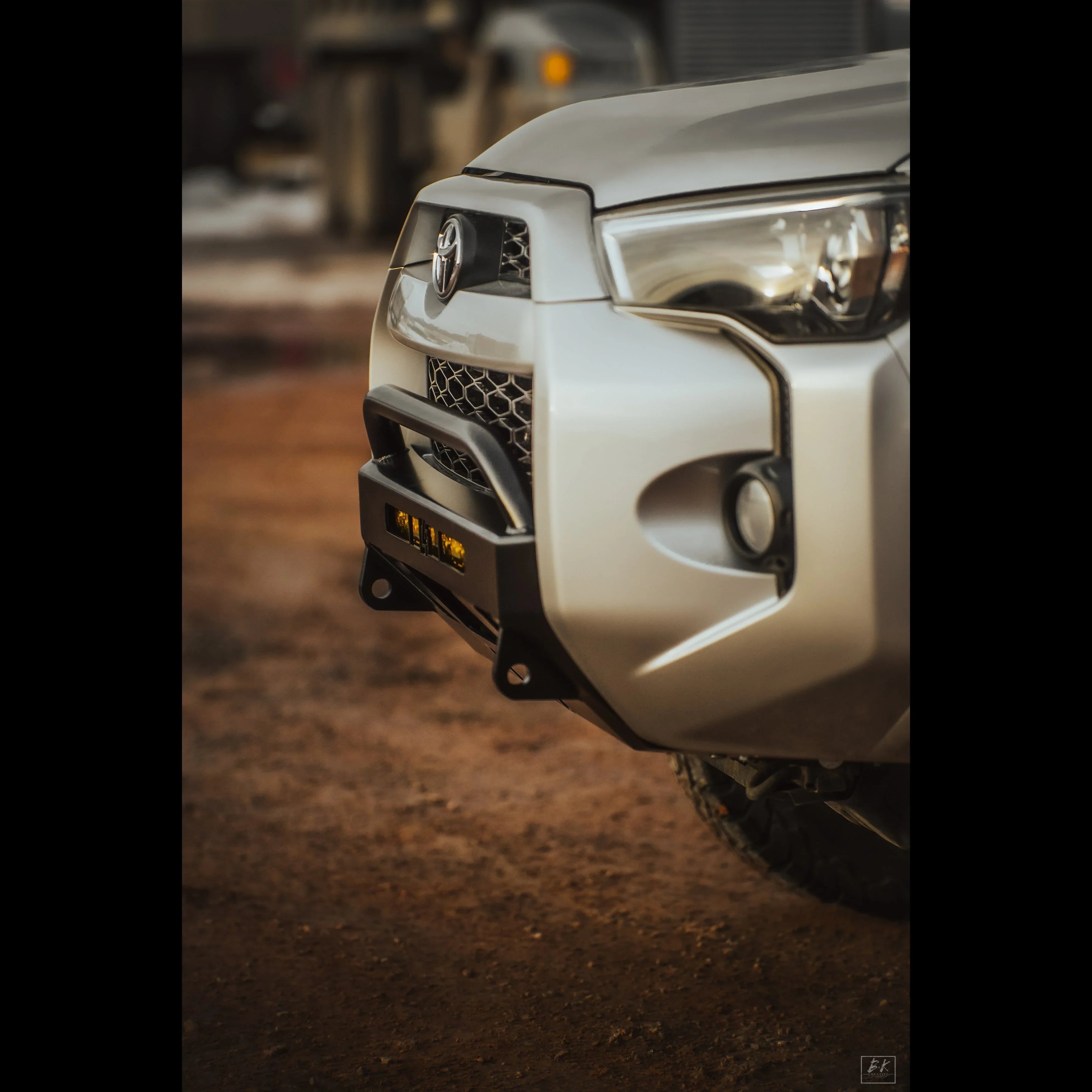 Toyota 4Runner with front low profile off-road bumper and LED lights on dirt road