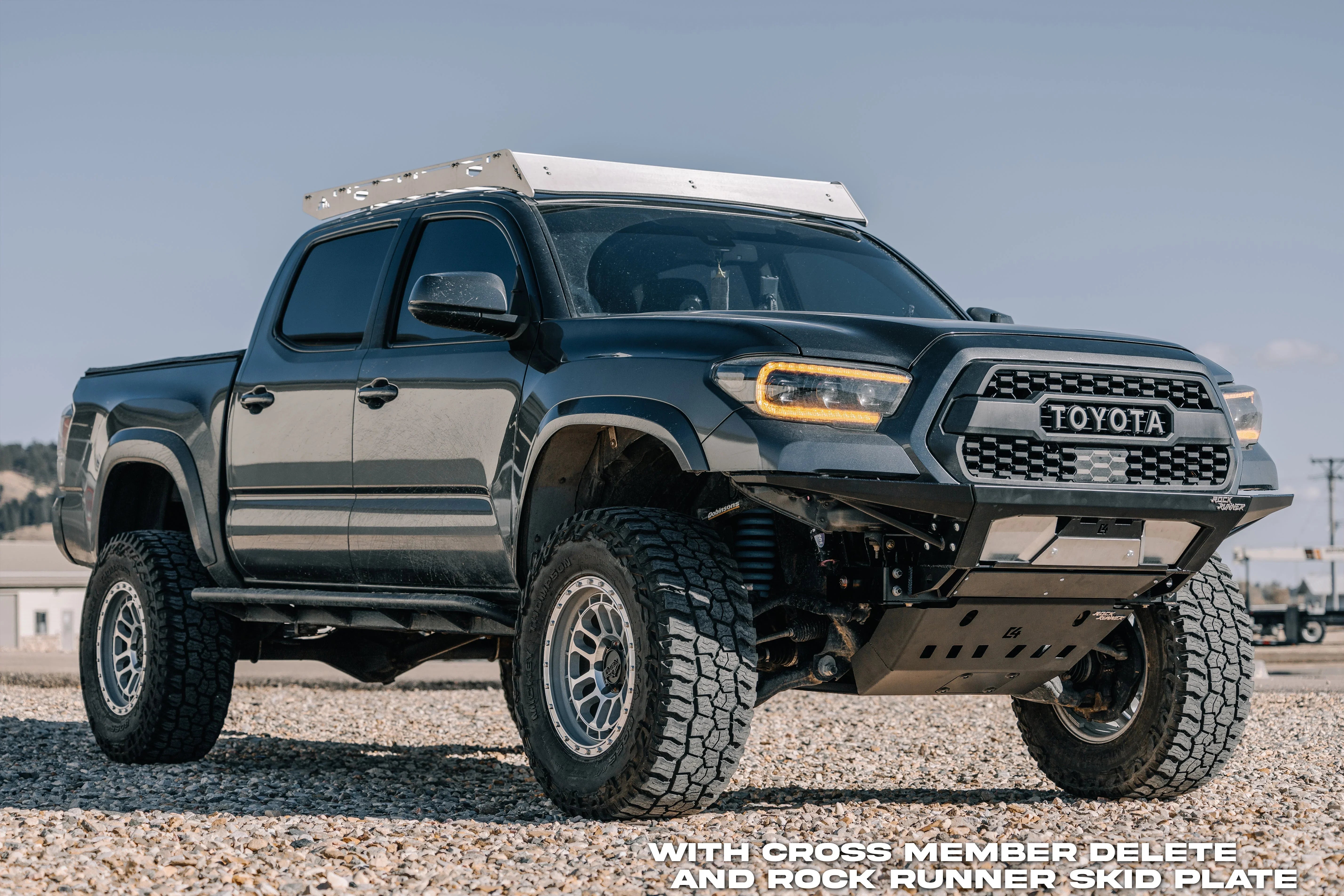 Toyota Tacoma with off-road modifications, cross member delete, and Rock Runner skid plate