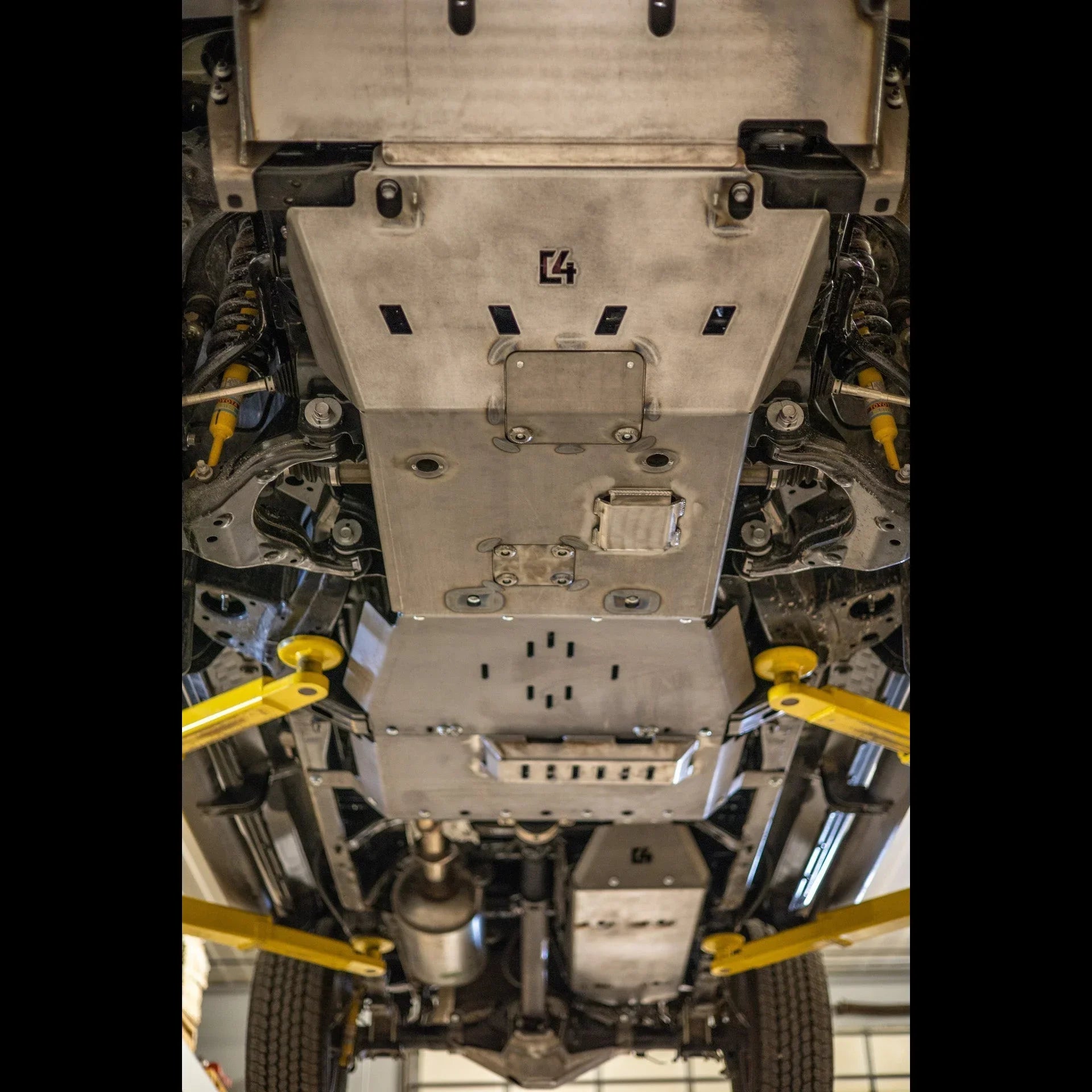 Steel skid plate installed on vehicle undercarriage for off-road protection