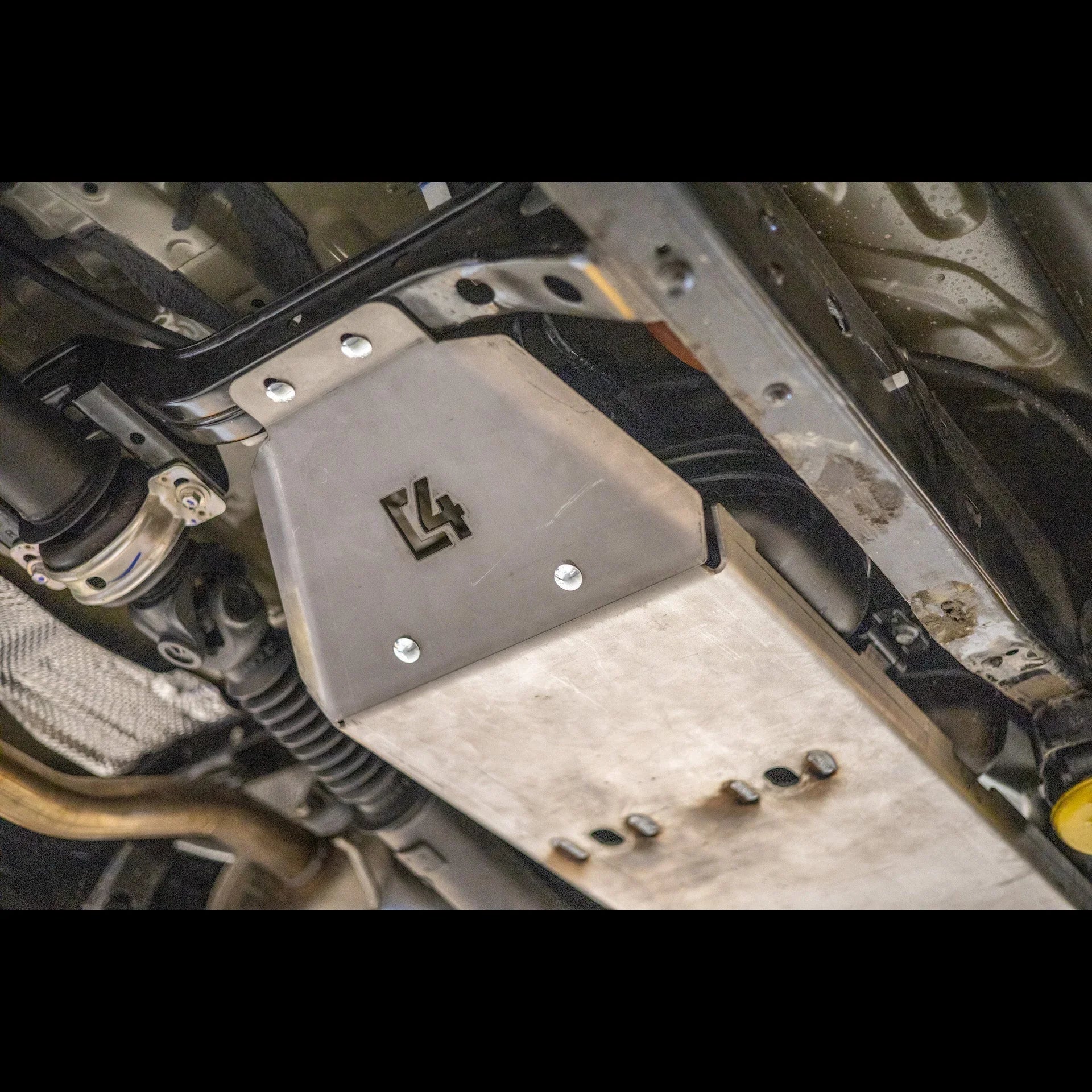 Steel skid plate installed under a vehicle for off-road and overlanding protection