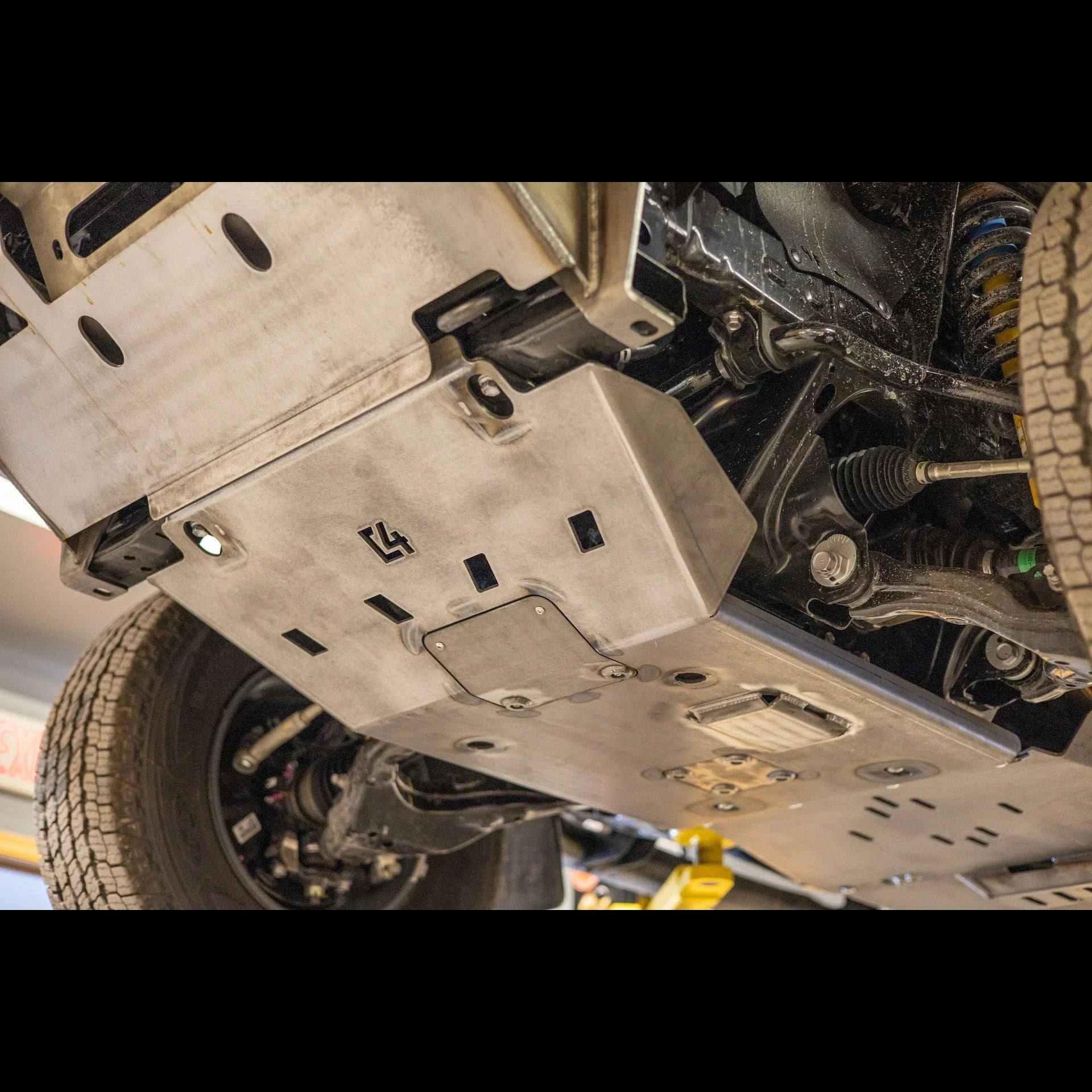 Heavy-duty steel skid plate installed on vehicle undercarriage for off-road protection
