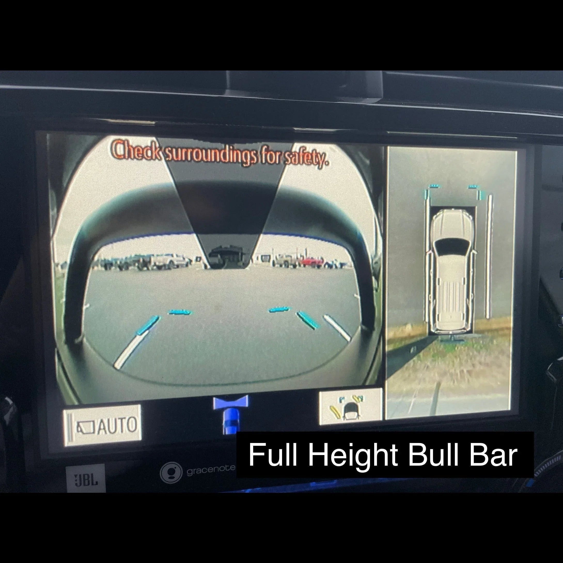 Vehicle rearview camera display showing full height bull bar and parking assist guides