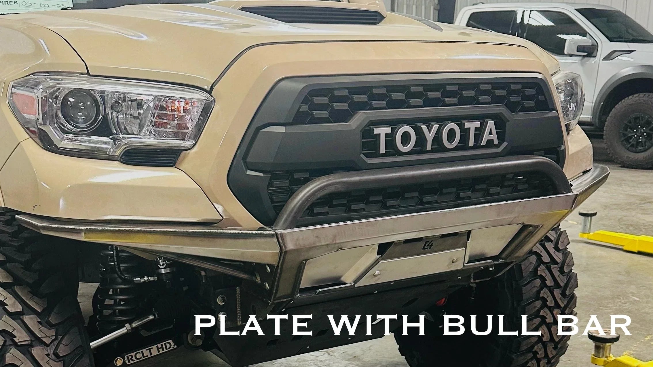 Toyota Tacoma front bumper with bull bar and off-road plate, fitted for overlanding