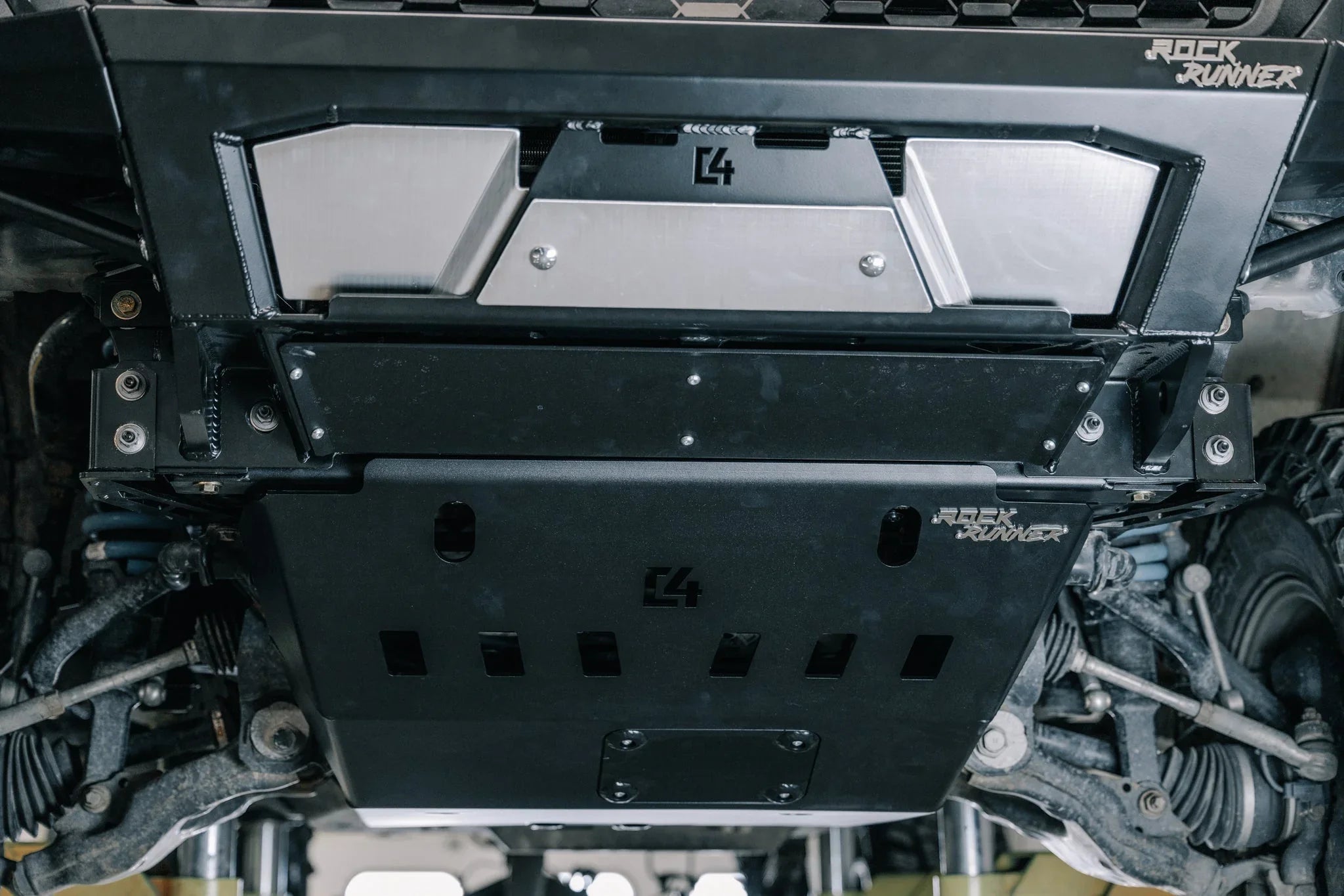 Heavy-duty skid plate and off-road armor installed under a 4x4 vehicle for protection