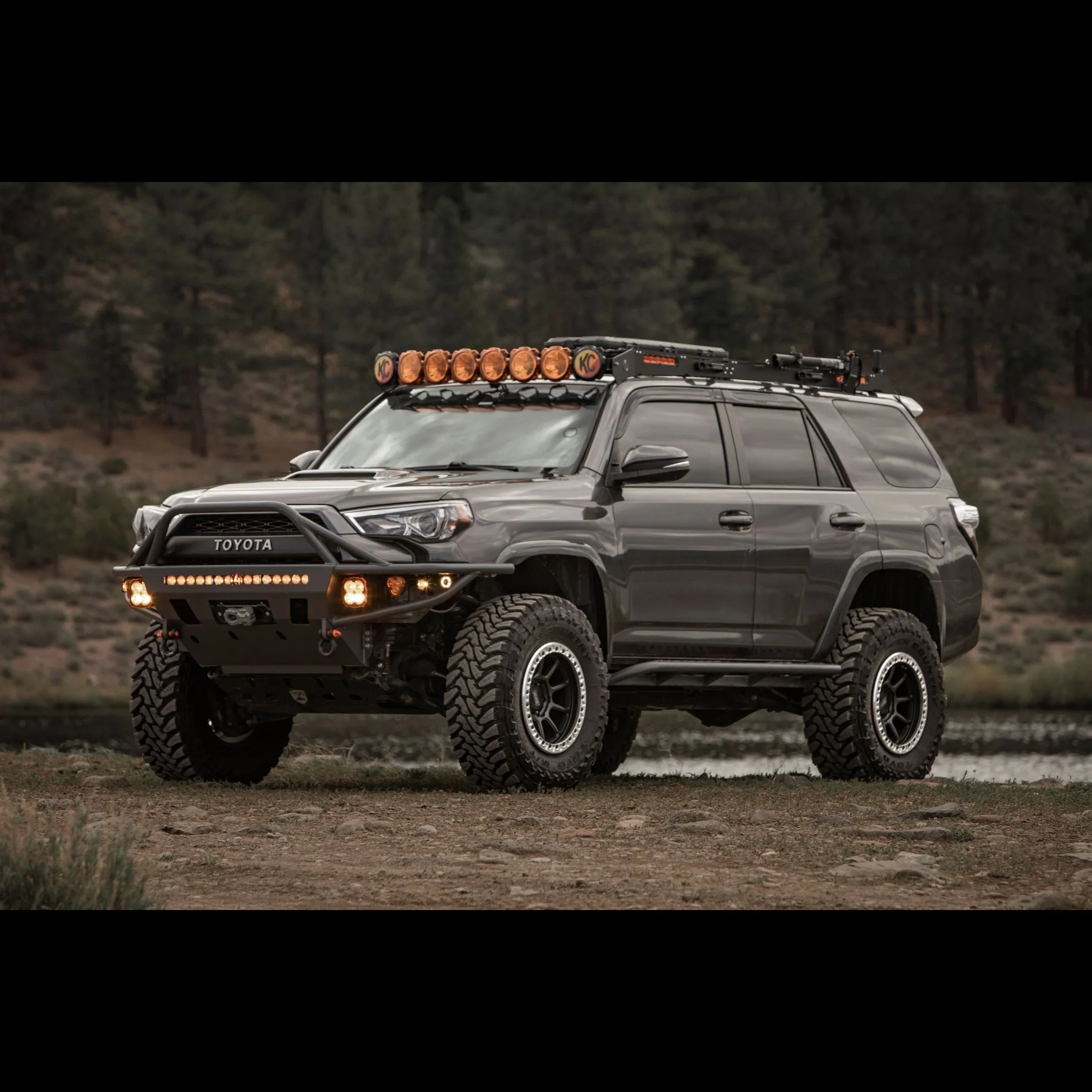 Lifted Toyota 4Runner with off-road lights, roof rack, and rugged tires outdoors