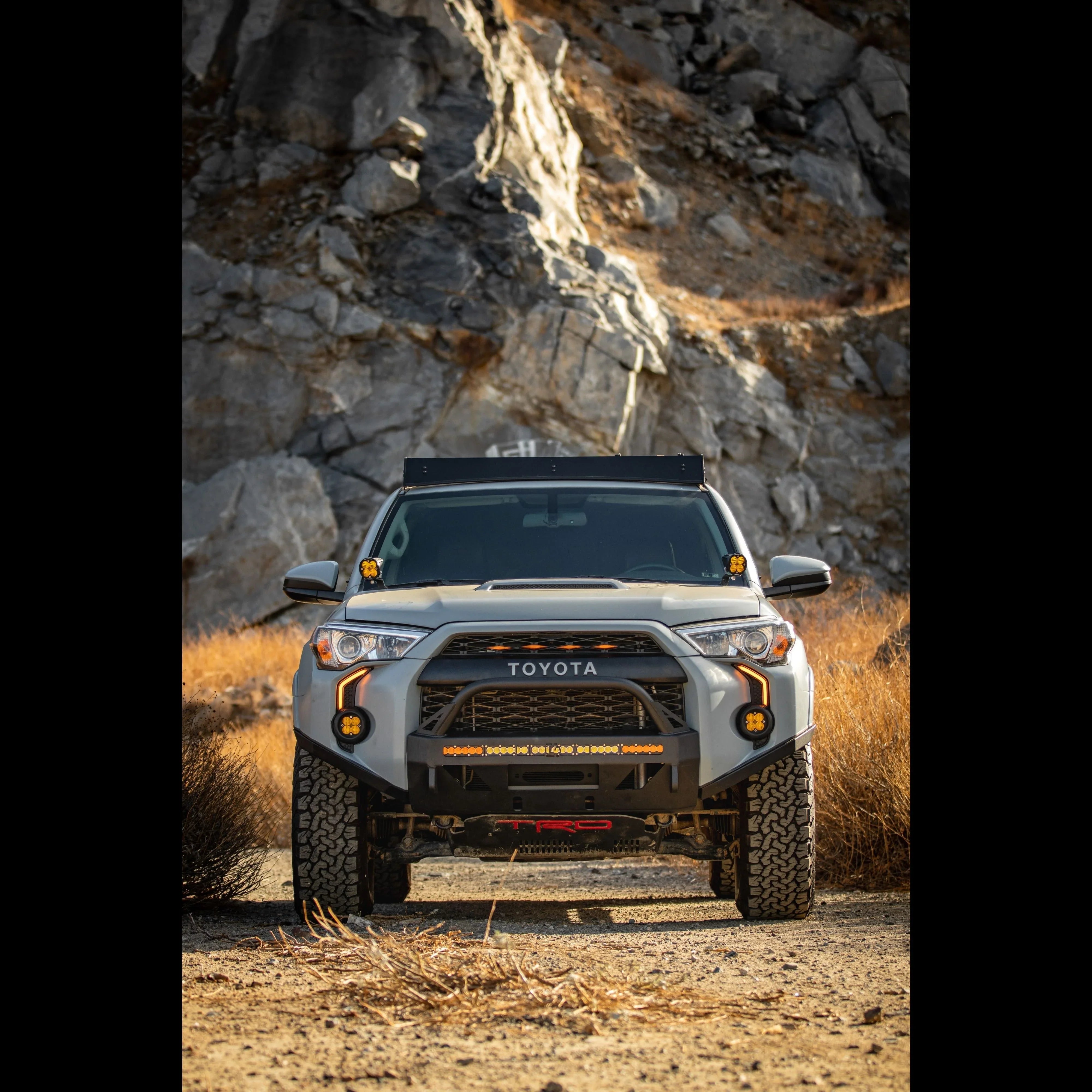 Toyota 4Runner overland build with off-road lights and accessories on rocky trail