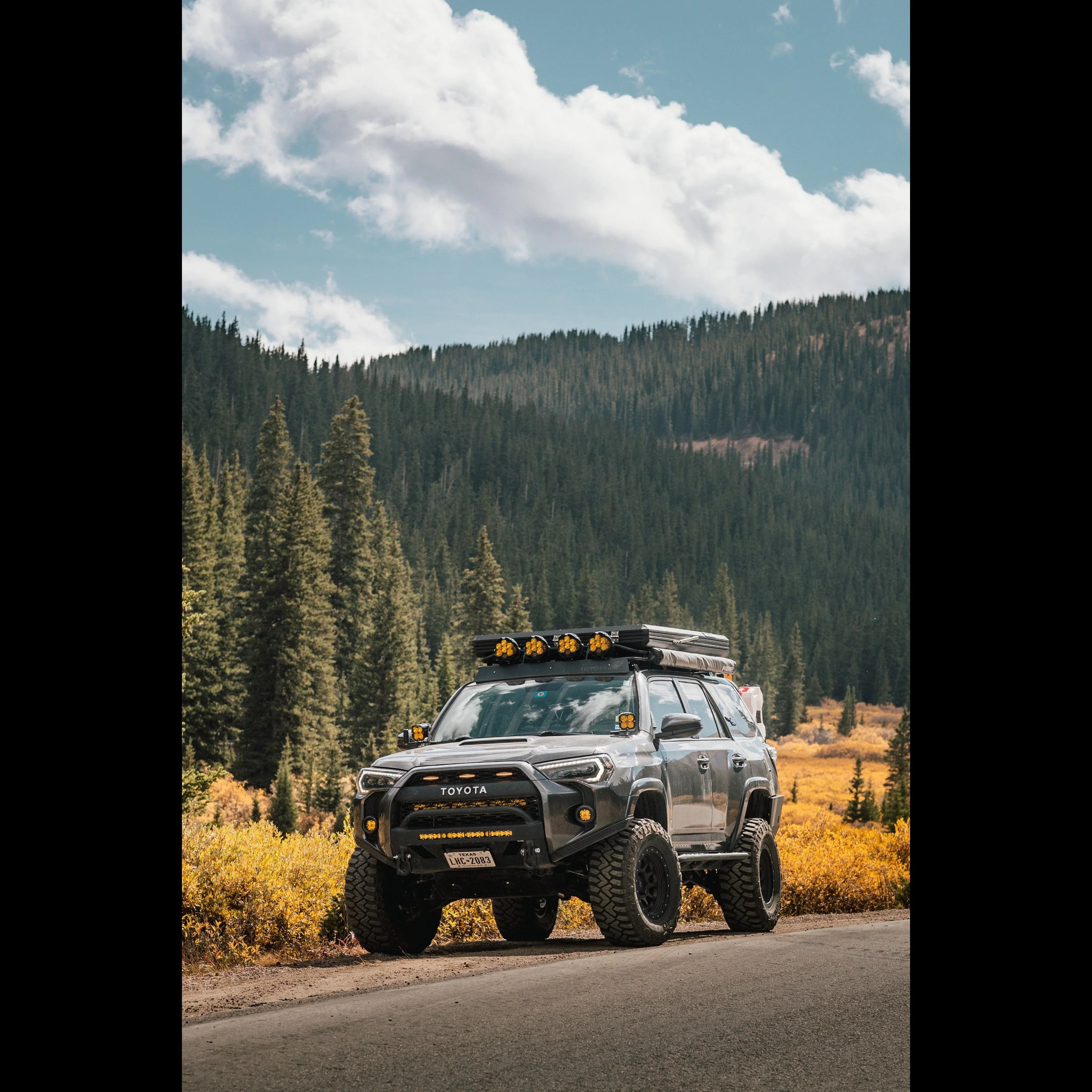 Toyota 4Runner overland build with camping accessories parked in scenic mountain forest