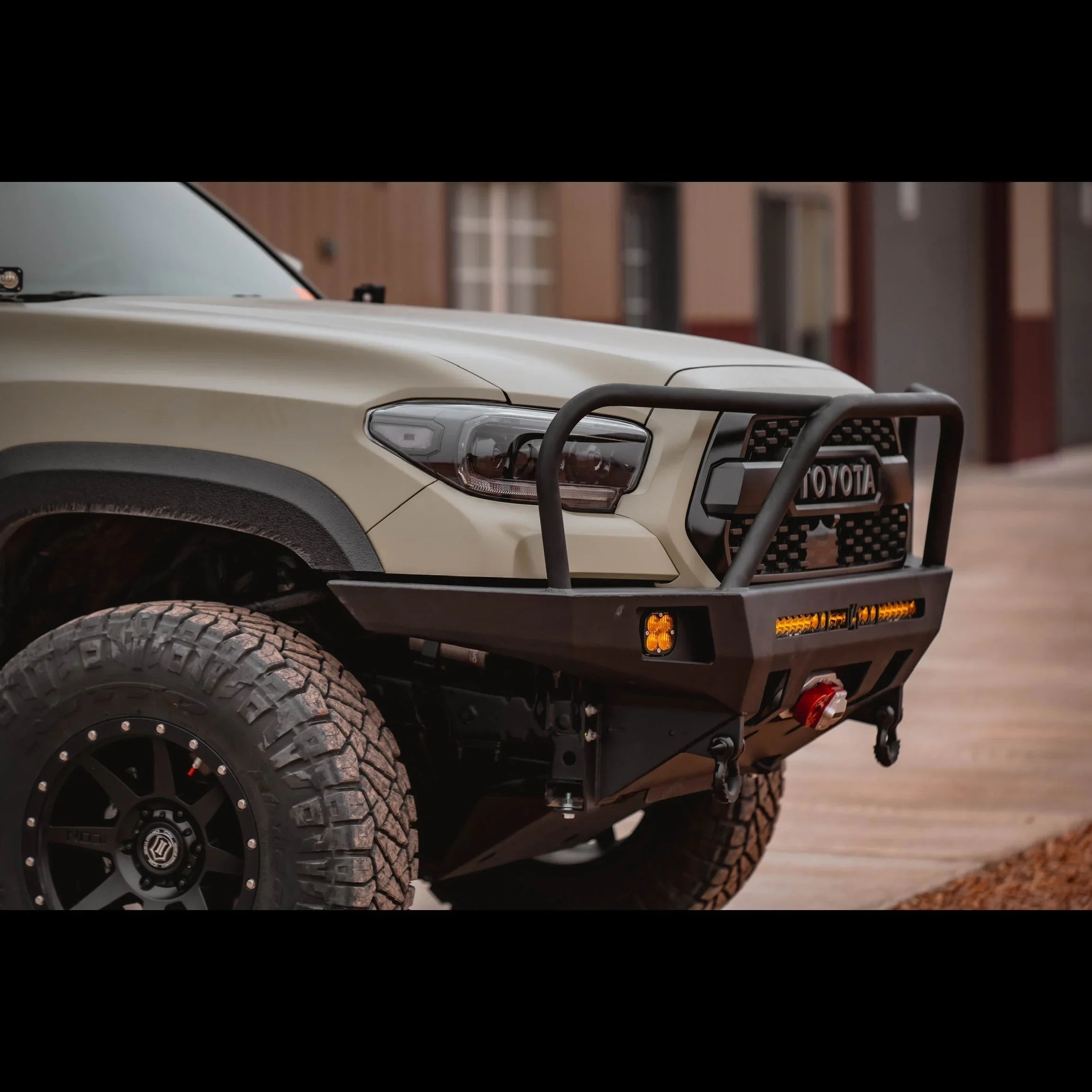 2016 Toyota Tacoma with overland front bumper, off-road tires, and LED lights