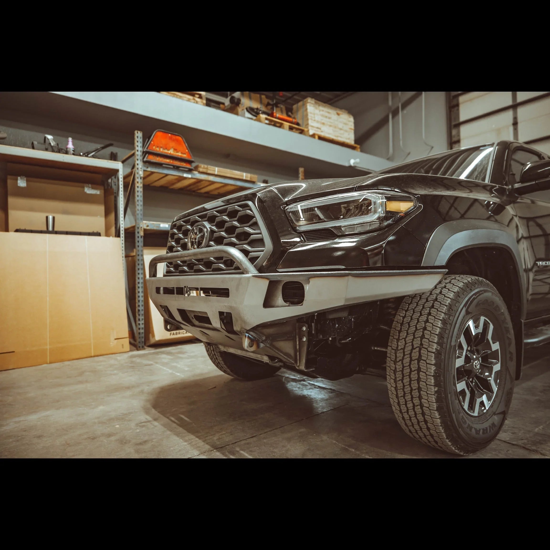 Toyota Tacoma 3rd Gen with overland front bumper in garage setting