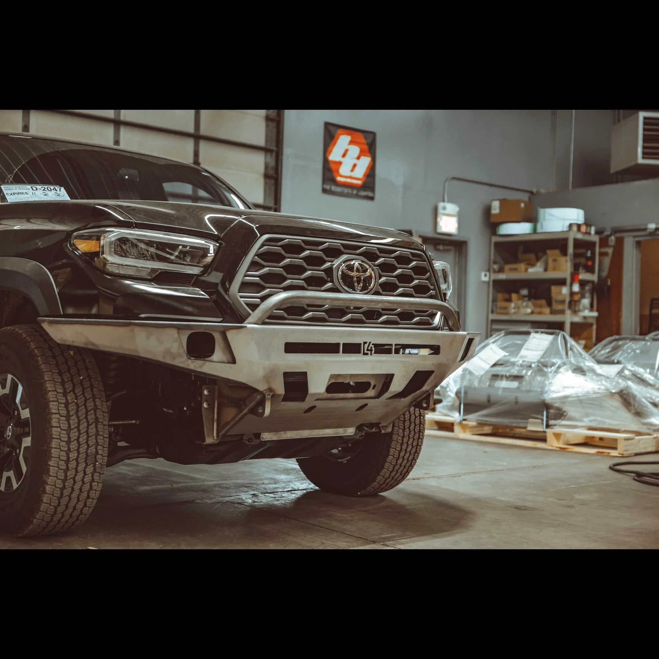 Toyota Tacoma with overland front bumper in a garage, 3rd gen 2016-2021, off-road accessory
