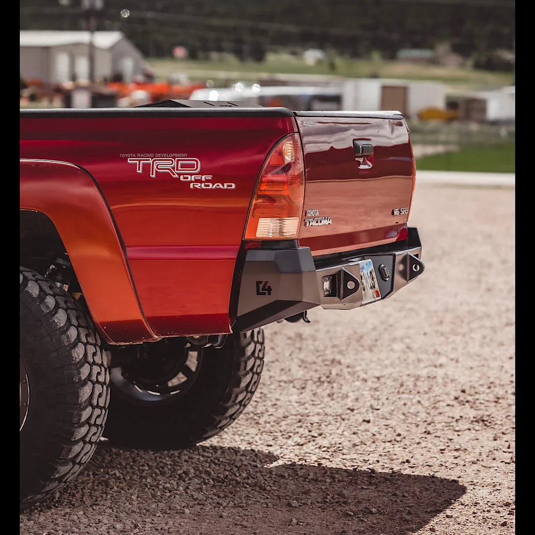 Steel overland rear bumper installed on red Toyota Tacoma 2005-2015, off-road setup