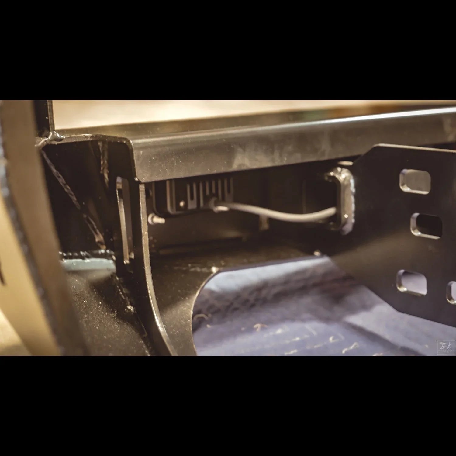 Close-up of steel rear bumper mount with wiring for Toyota Tacoma overland accessories