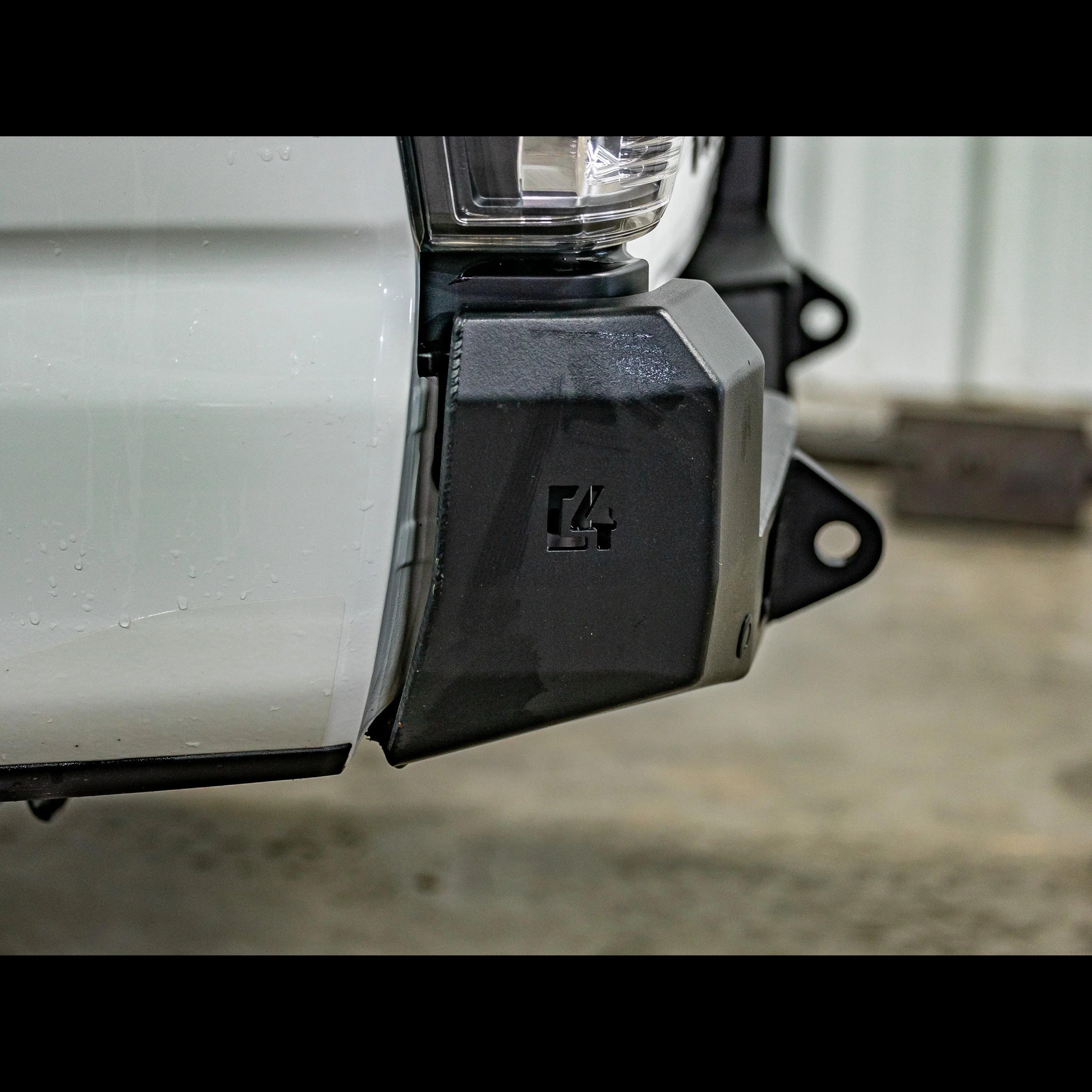 Close-up of black steel overland rear bumper on white 3rd gen Toyota Tacoma