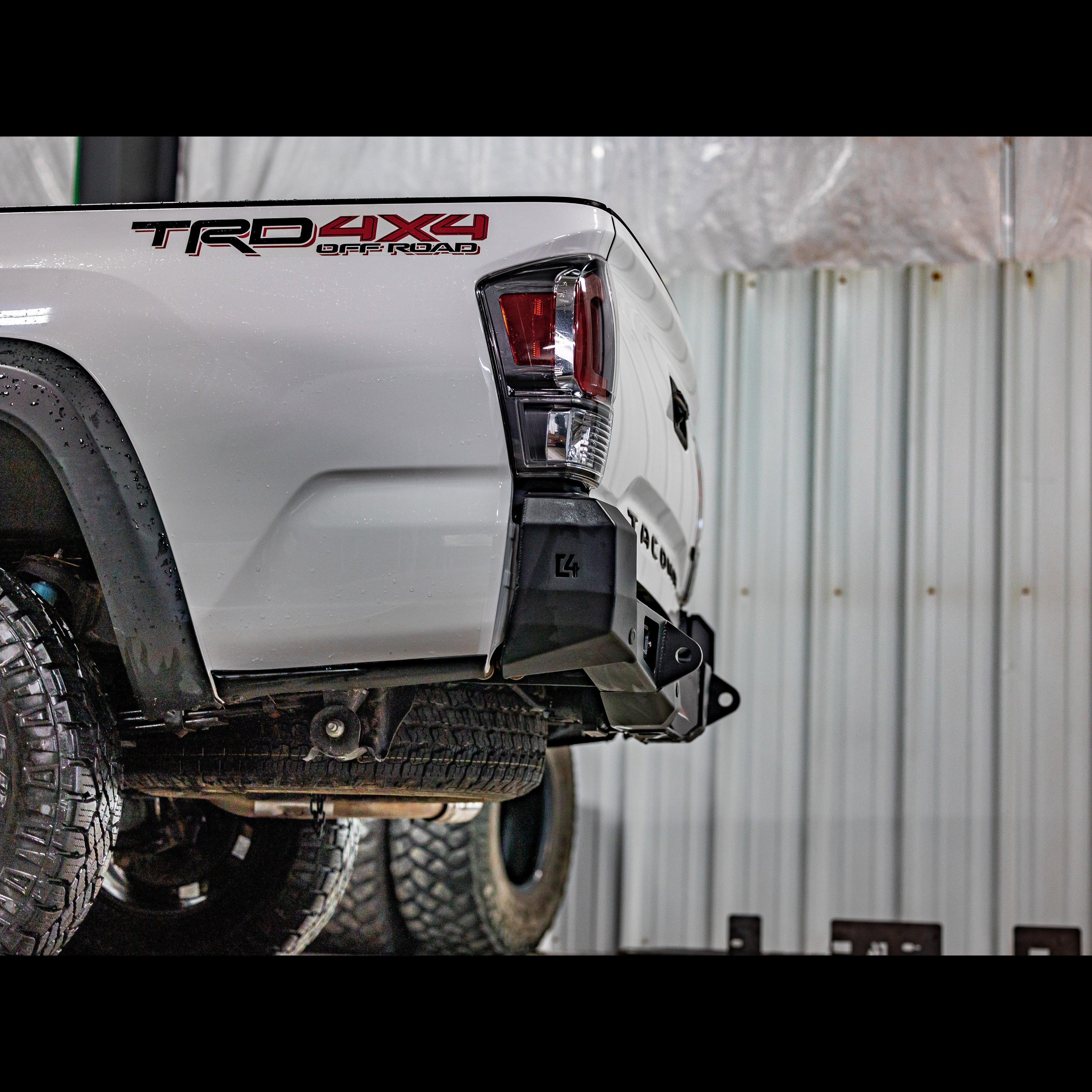 Toyota Tacoma 3rd Gen with off-road rear bumper, TRD 4x4 decal, rugged tires, garage setting