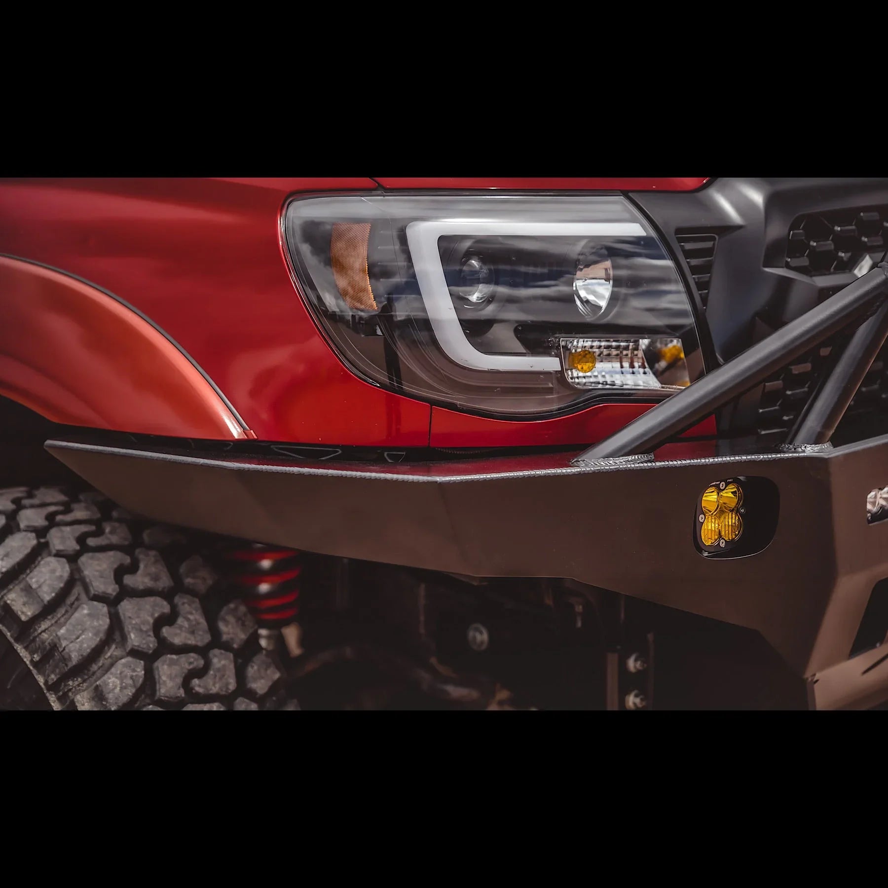 Toyota Tacoma overland front bumper with off-road tire and grille detail