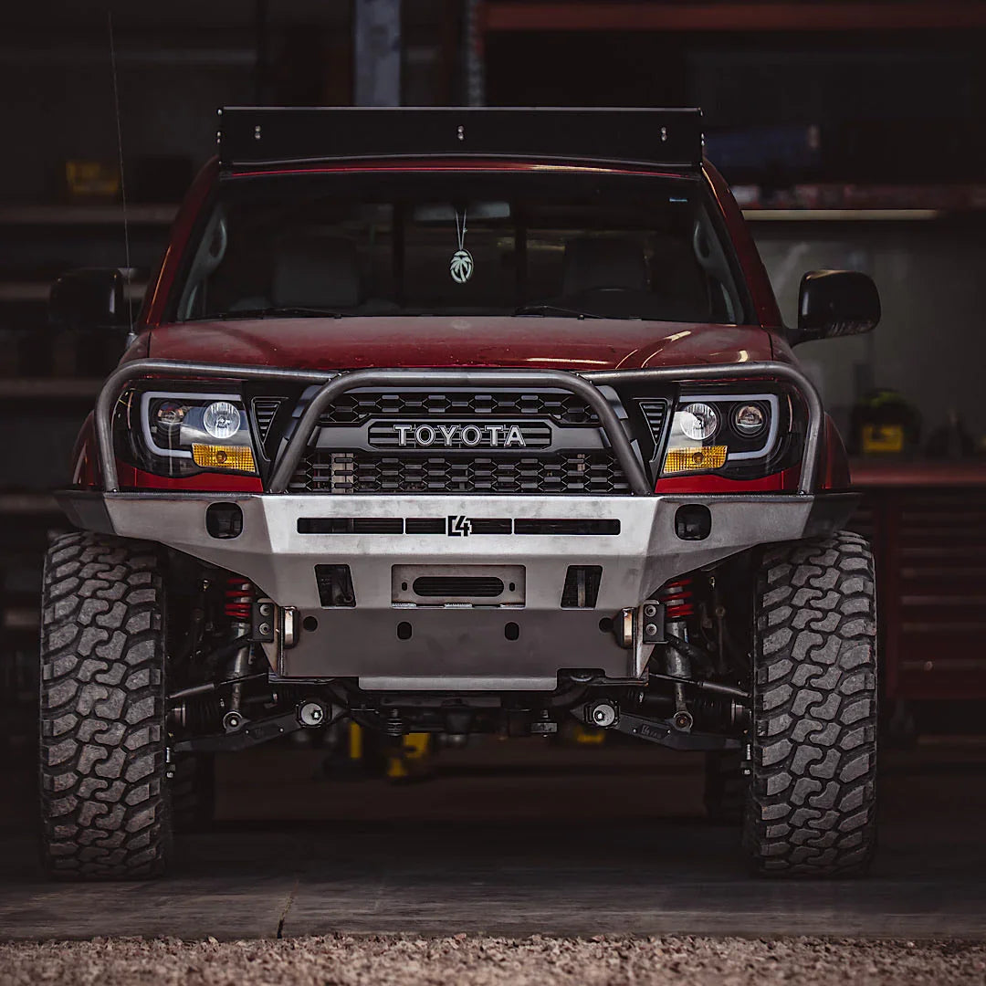 Front view of Toyota Tacoma with overland steel off-road bumper and rugged tires