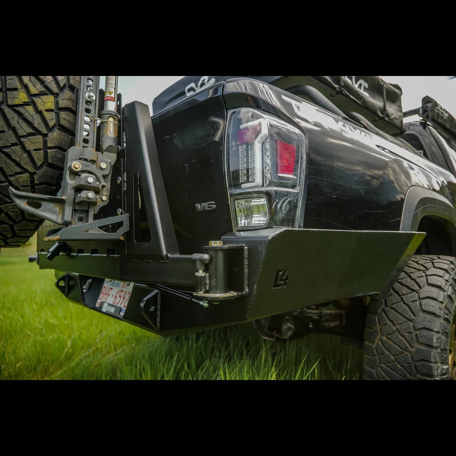 High clearance rear bumper with tire carrier on Toyota Tacoma overland truck