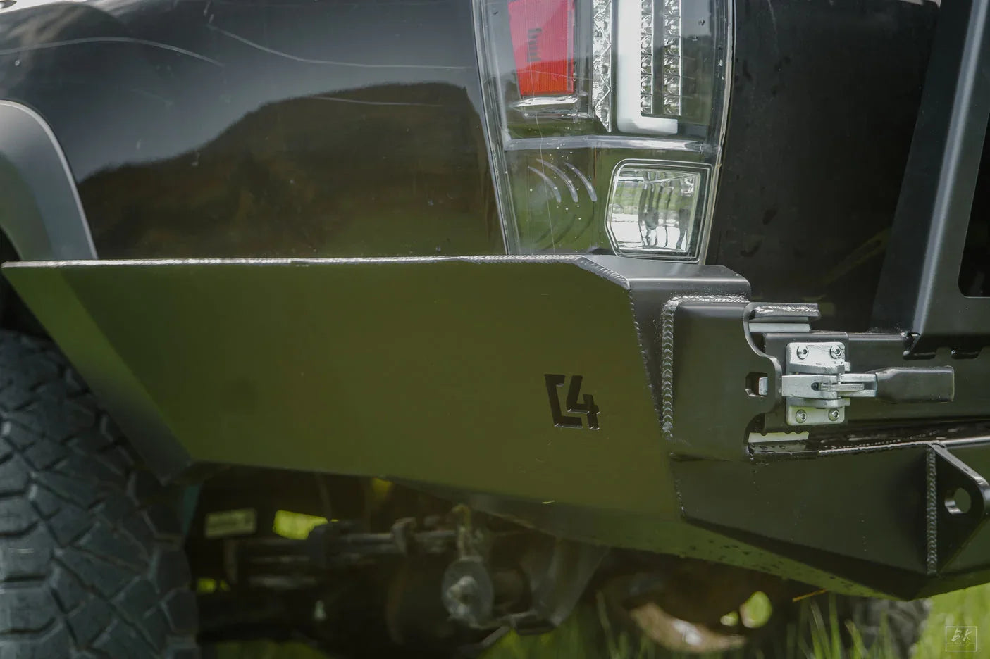 High clearance rear bumper on Toyota Tacoma, off-road tire, close-up, overland accessory