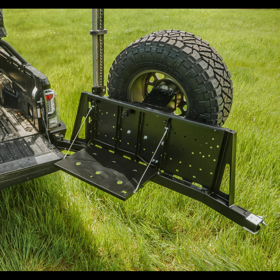 Toyota Tacoma high clearance rear bumper with swing-out tire carrier on grassy field