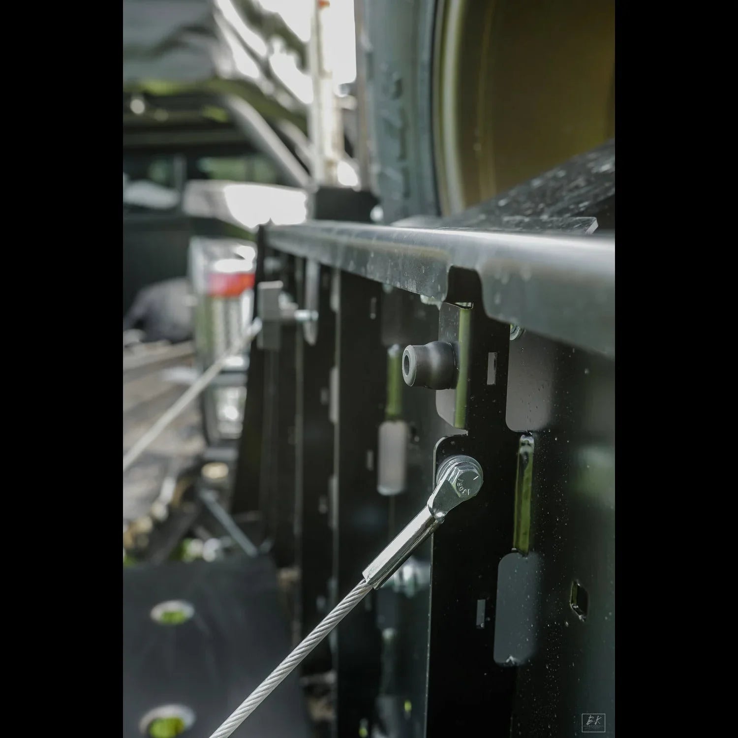 Close-up of high clearance rear bumper with reinforced steel and cable on Toyota Tacoma.