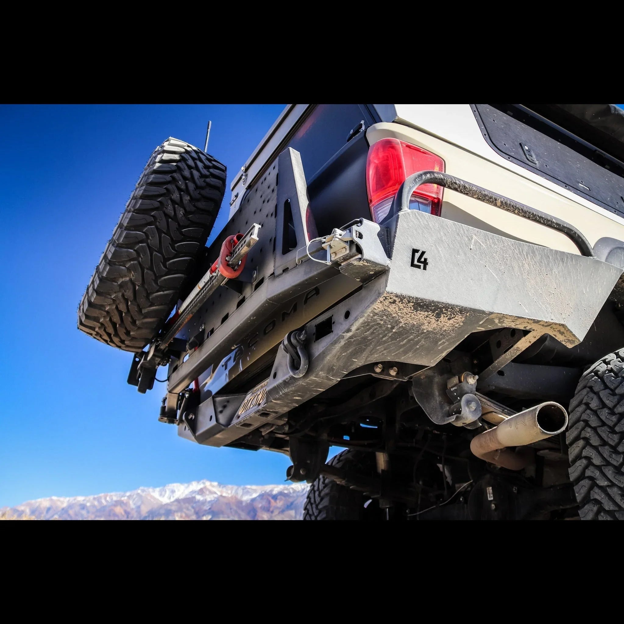 Toyota Tacoma overland rear bumper with spare tire carrier, off-road in mountains
