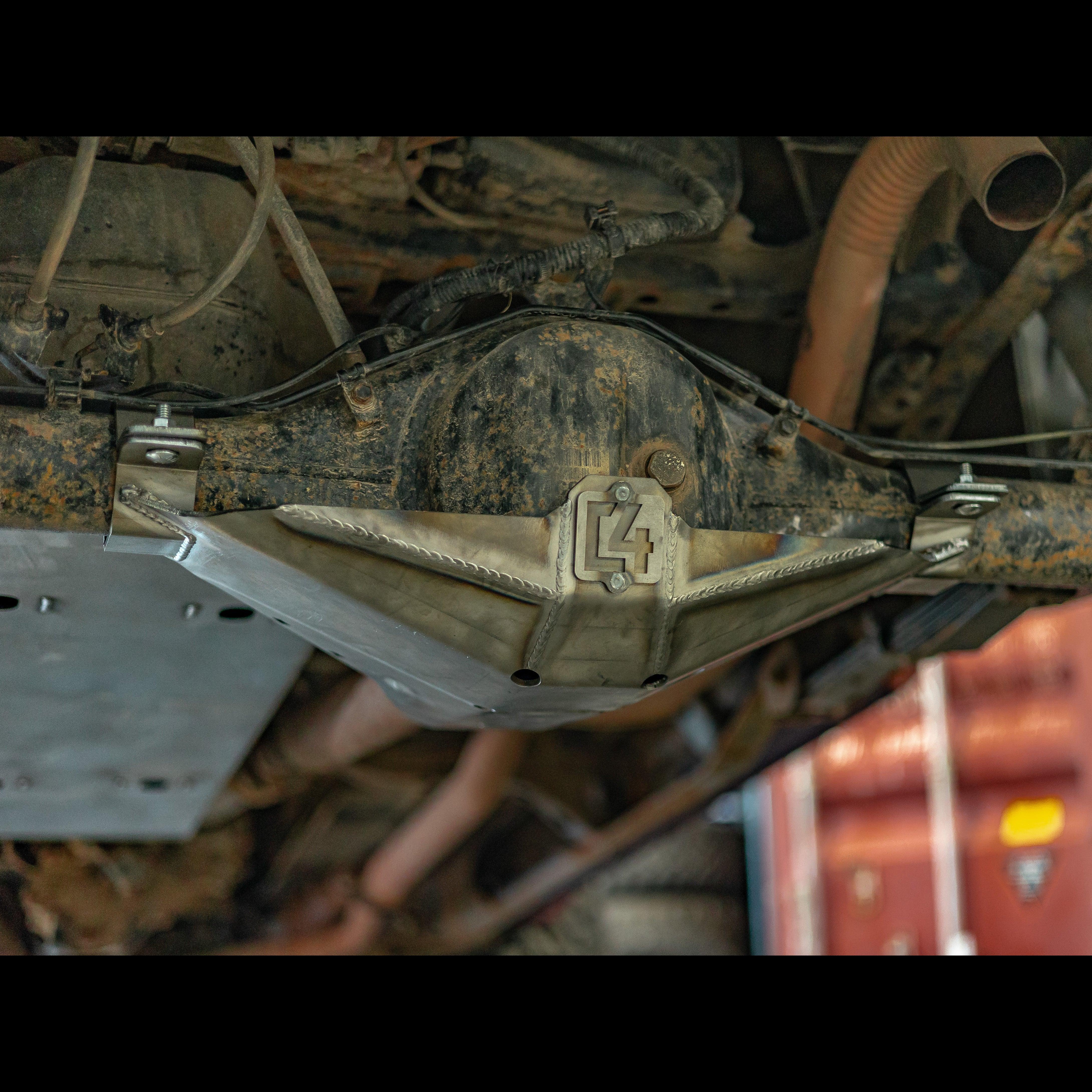 Steel rear differential skid plate installed on 2nd Gen Toyota Tacoma, undercarriage view.