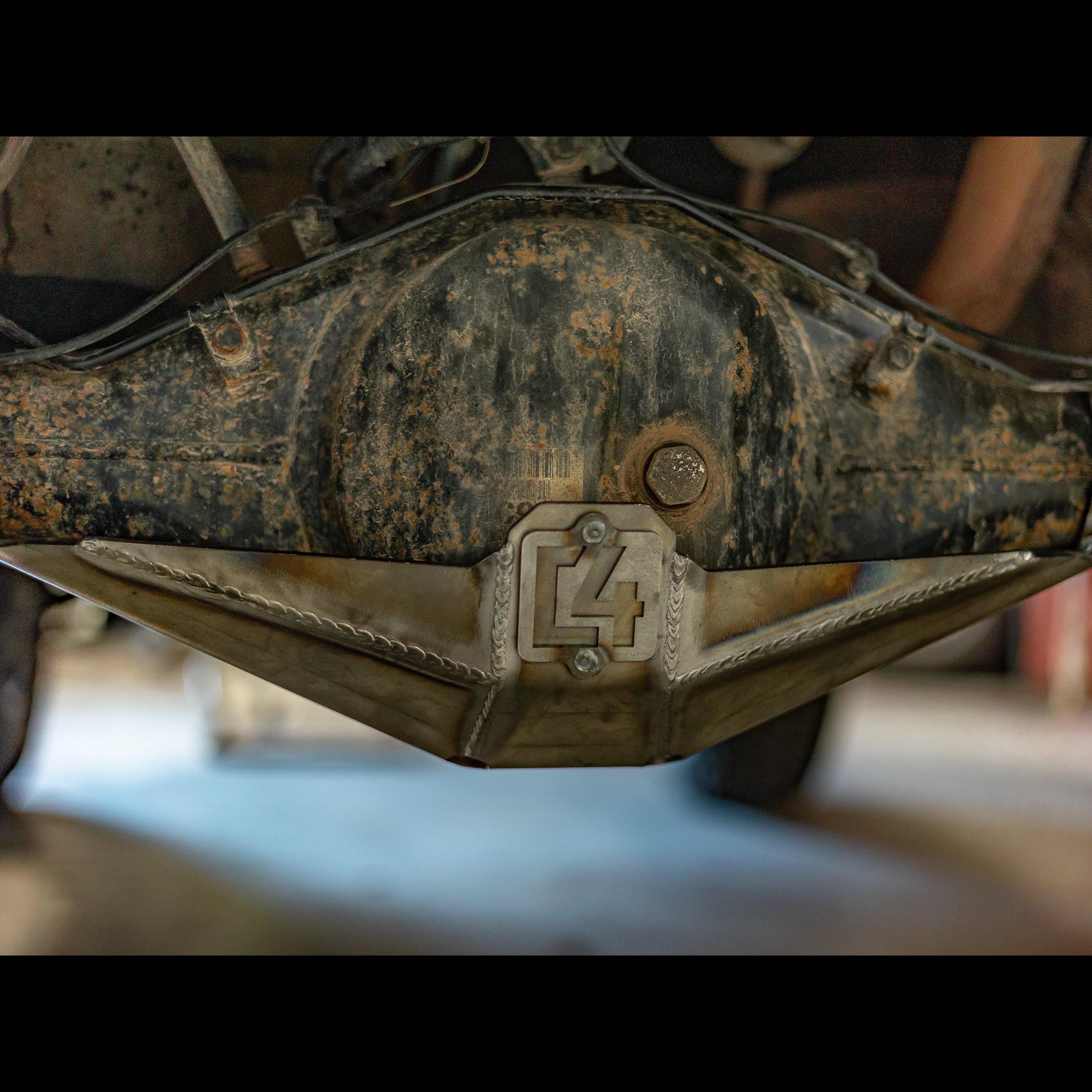 Steel rear differential skid plate installed on Toyota Tacoma, undercarriage off-road protection