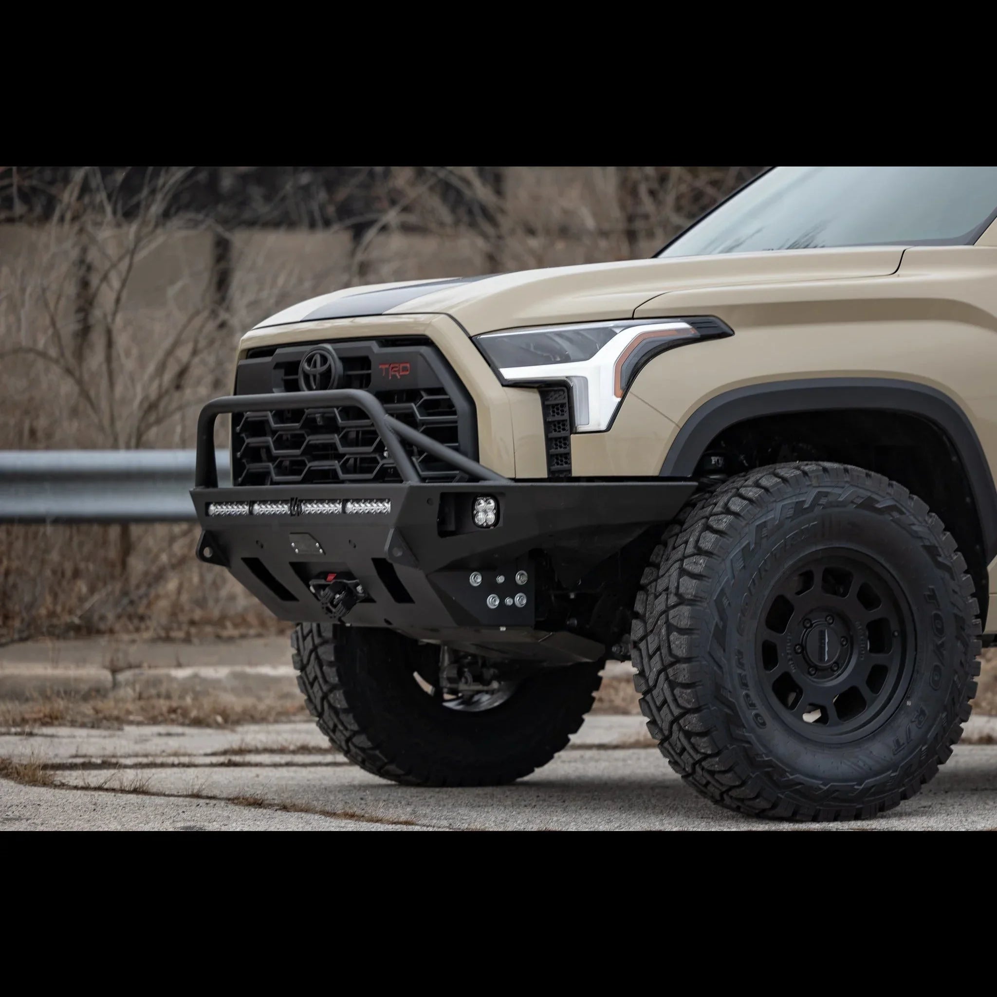 Heavy-duty overland front bumper on 2022 Toyota Tundra, off-road tires visible