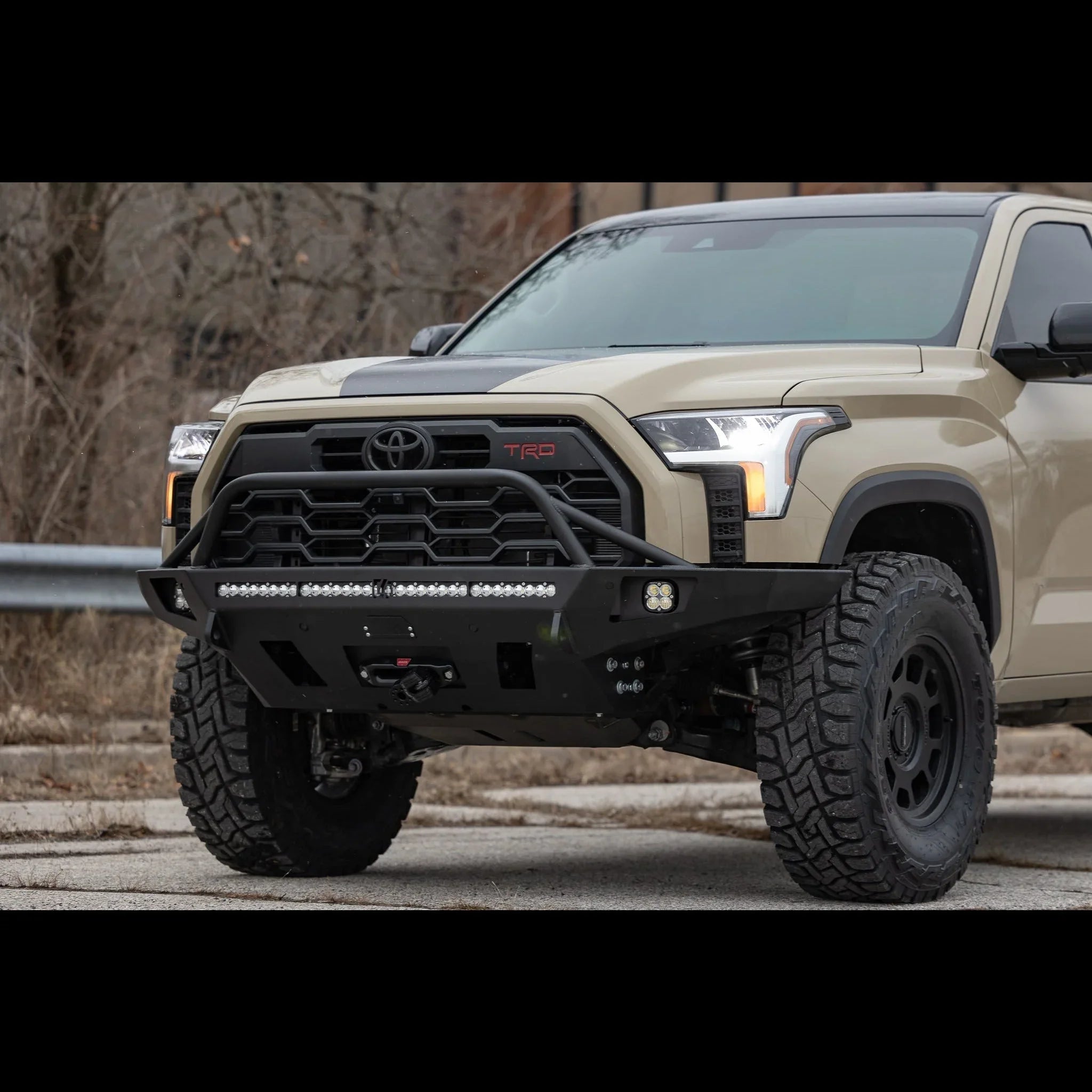 2022 Toyota Tundra with overland front bumper, off-road tires, and LED light bar