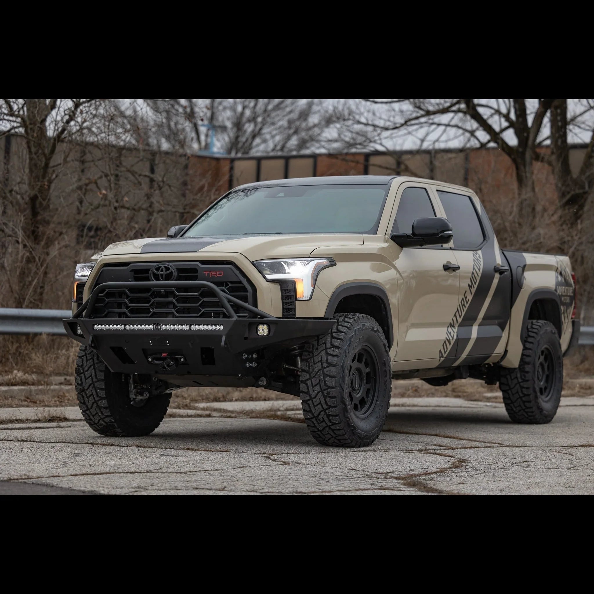 Toyota Tundra 3rd Gen with off-road front bumper and adventure mods, parked outdoors