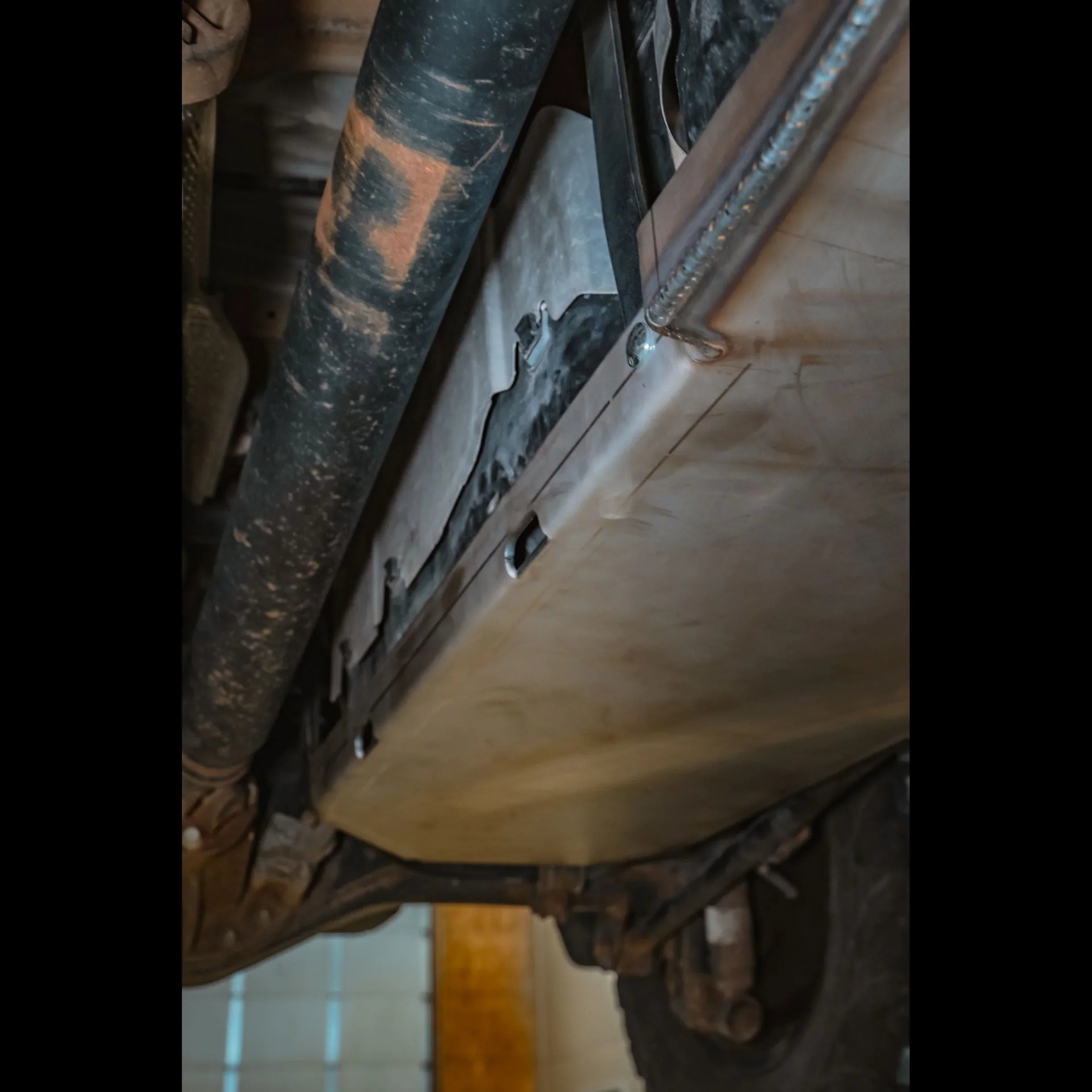 Heavy-duty gas tank skid plate installed under off-road vehicle for underbody protection