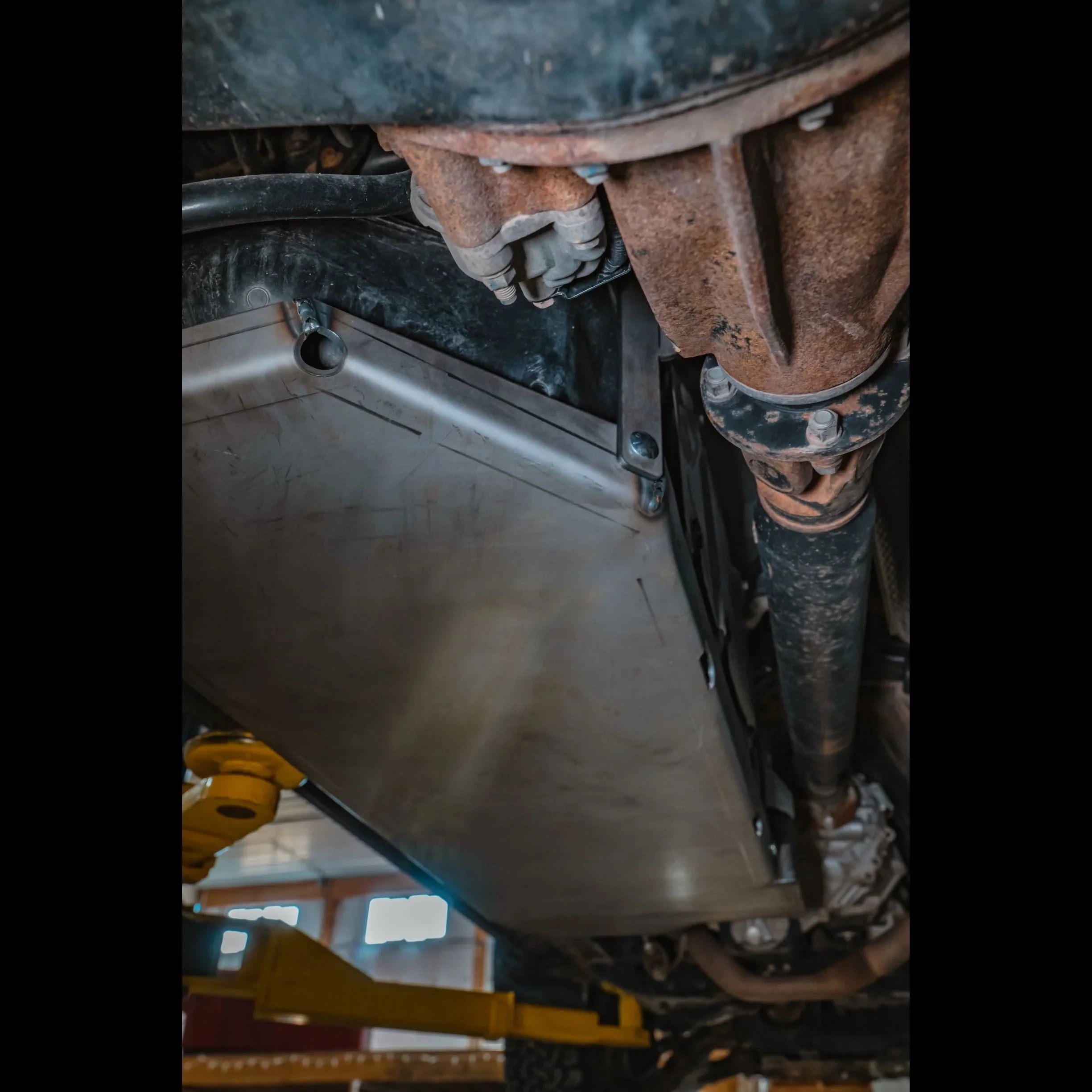 Heavy-duty gas tank skid plate installed under off-road vehicle for protection