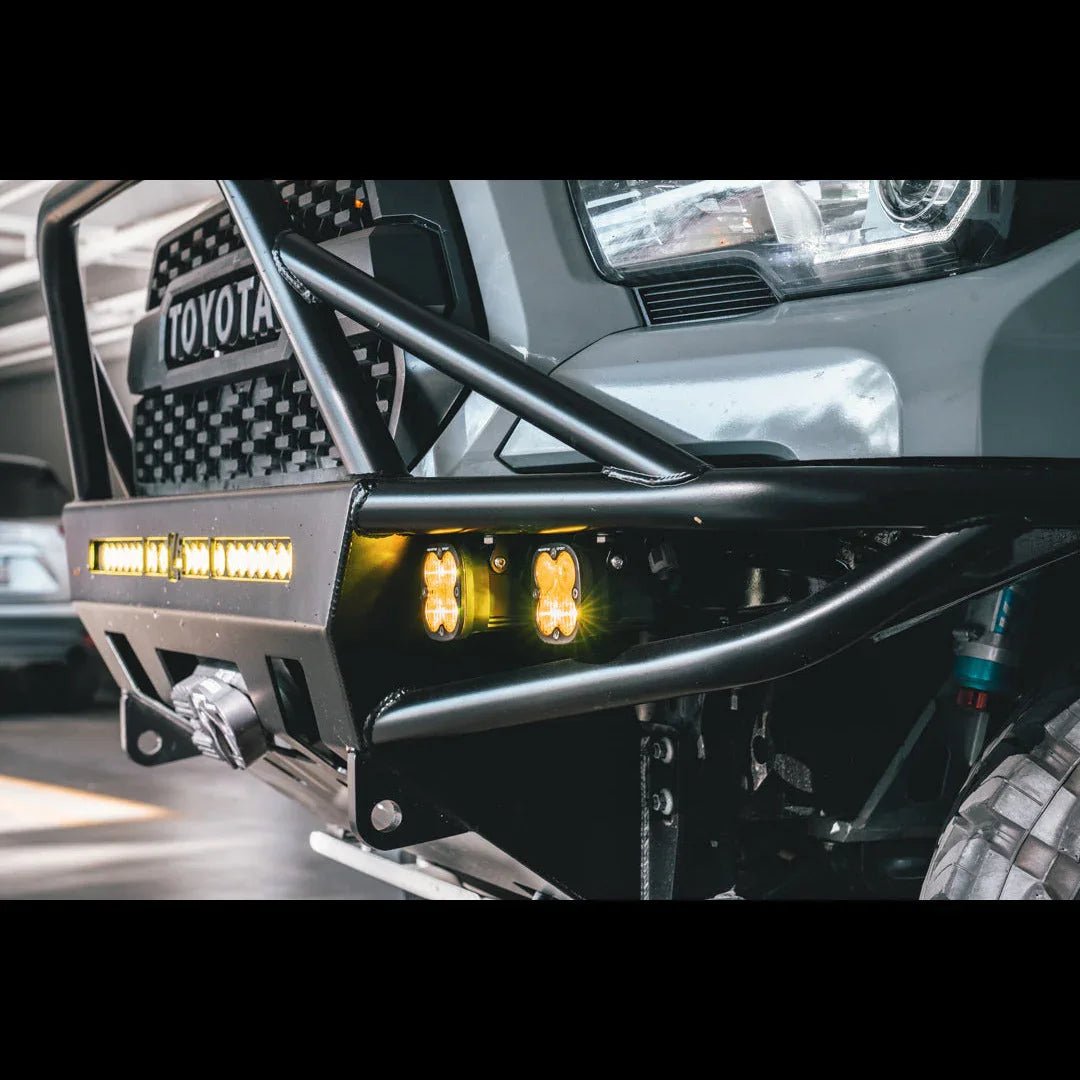 Toyota truck custom steel front bumper with off-road LED lights and winch in garage