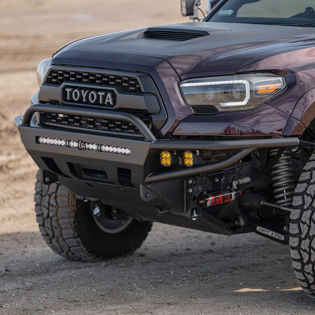 Toyota Tacoma with off-road steel front bumper, LED light bar, and rugged all-terrain tires