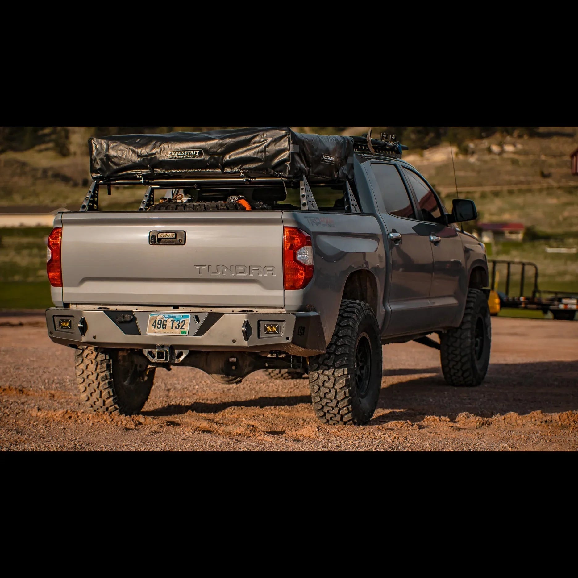 Toyota Tundra with roof rack, off-road tires, and camping gear loaded for overlanding.