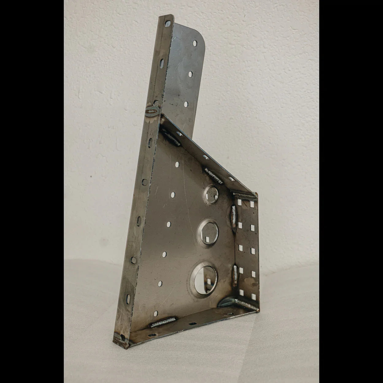 Steel rear bumper attachment bracket with multiple mounting holes for off-road vehicles