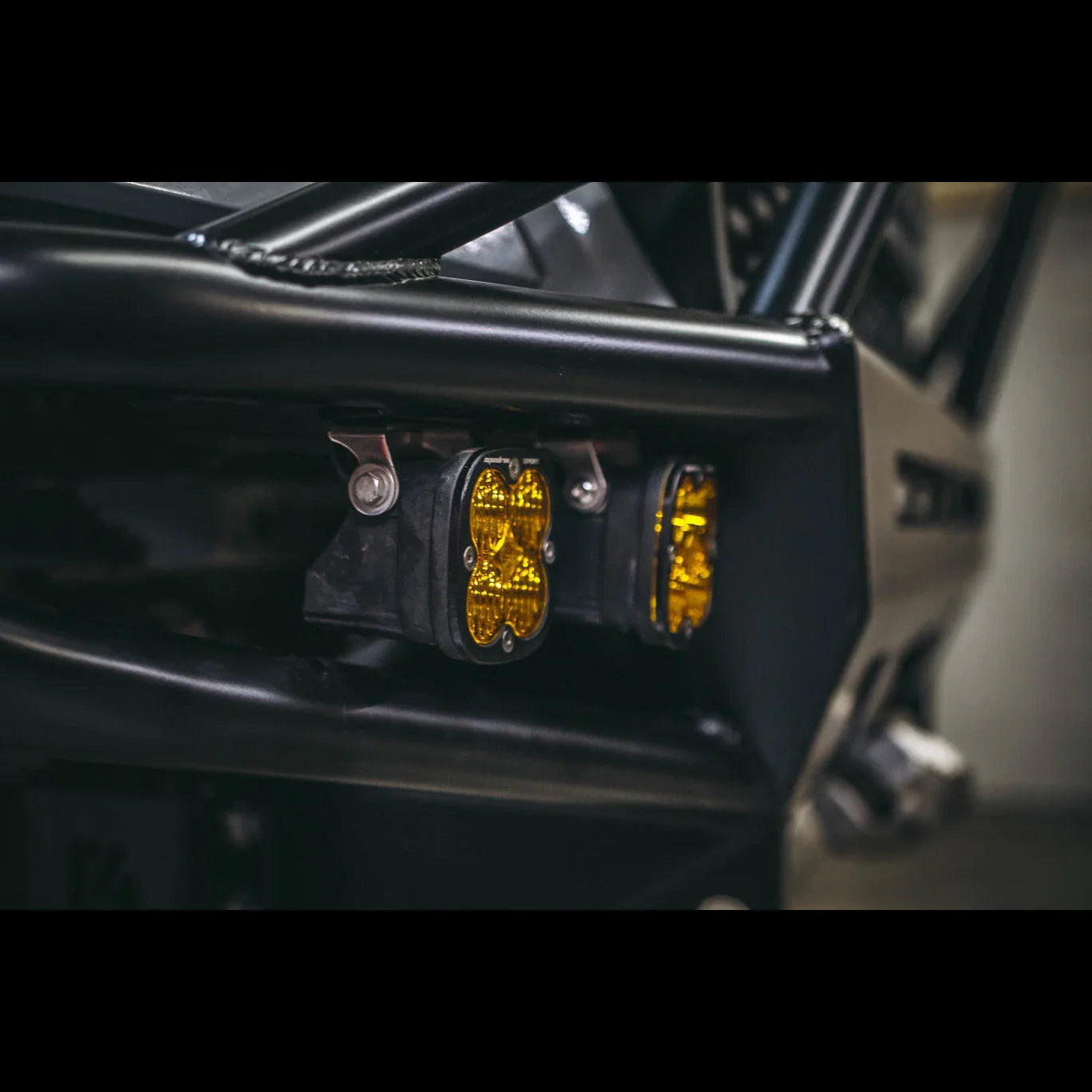 Close-up of off-road bumper with mounted yellow LED fog lights, suitable for overlanding vehicles.