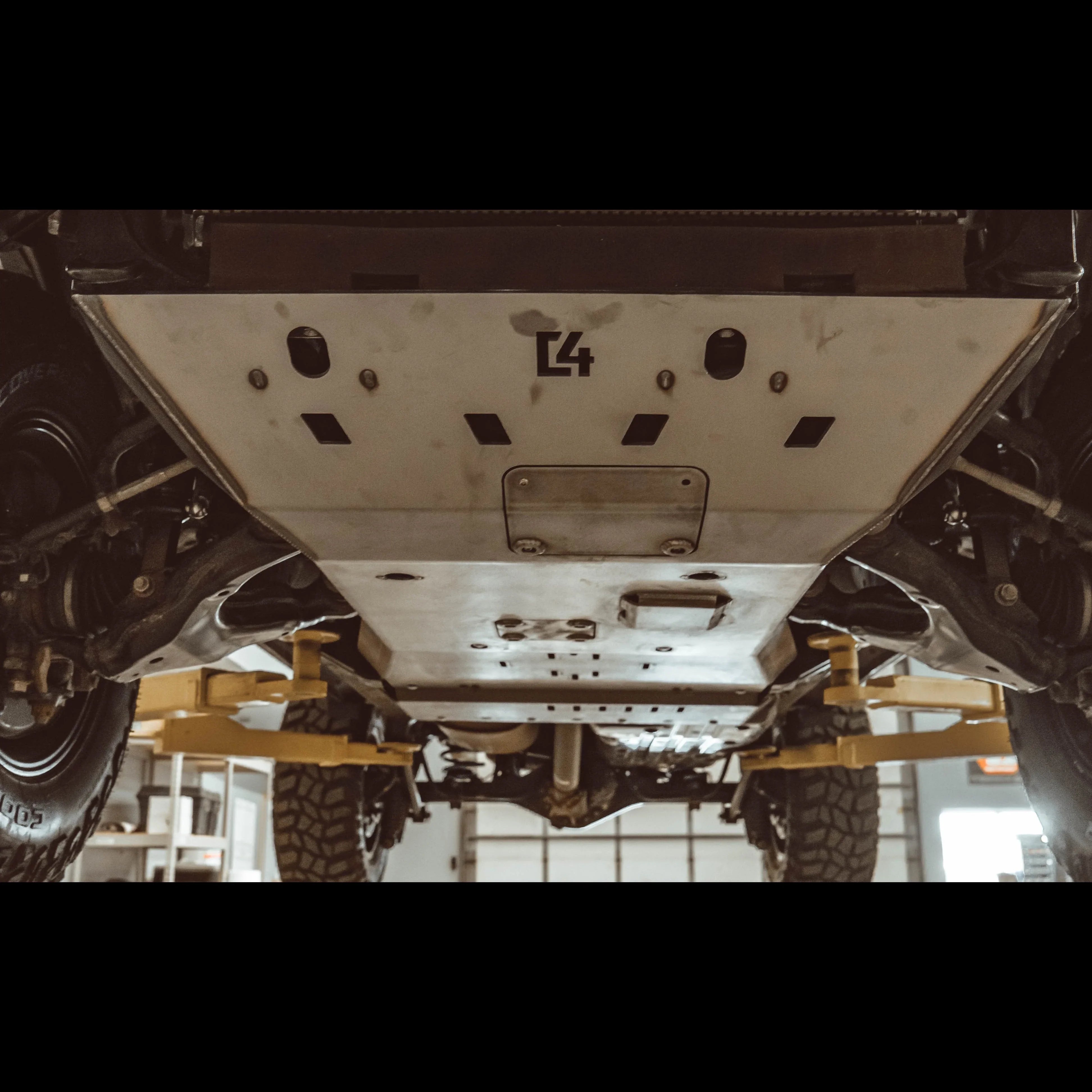 Heavy-duty skid plate installed under off-road vehicle for undercarriage protection
