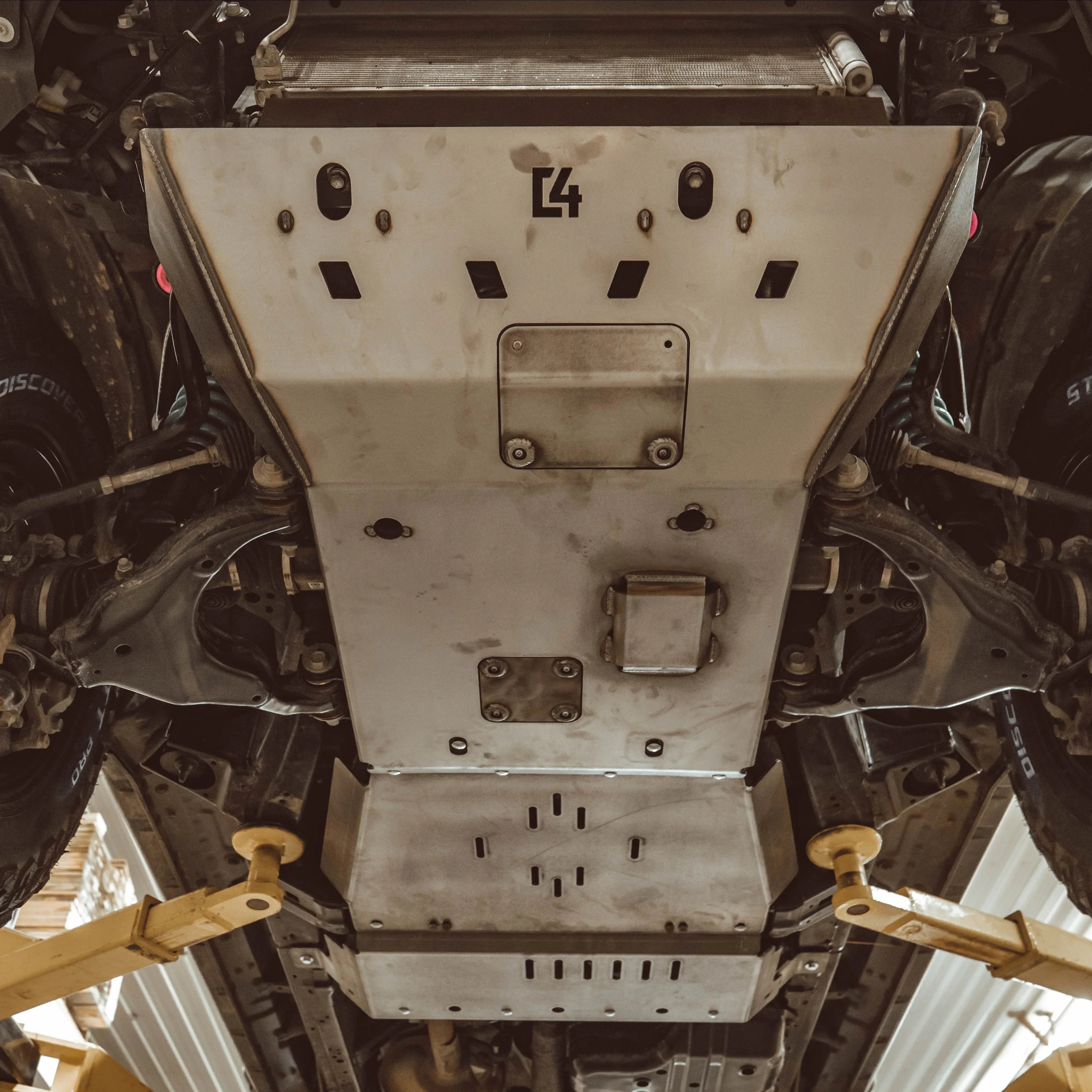Heavy-duty skid plate installed under off-road vehicle, protecting suspension and undercarriage