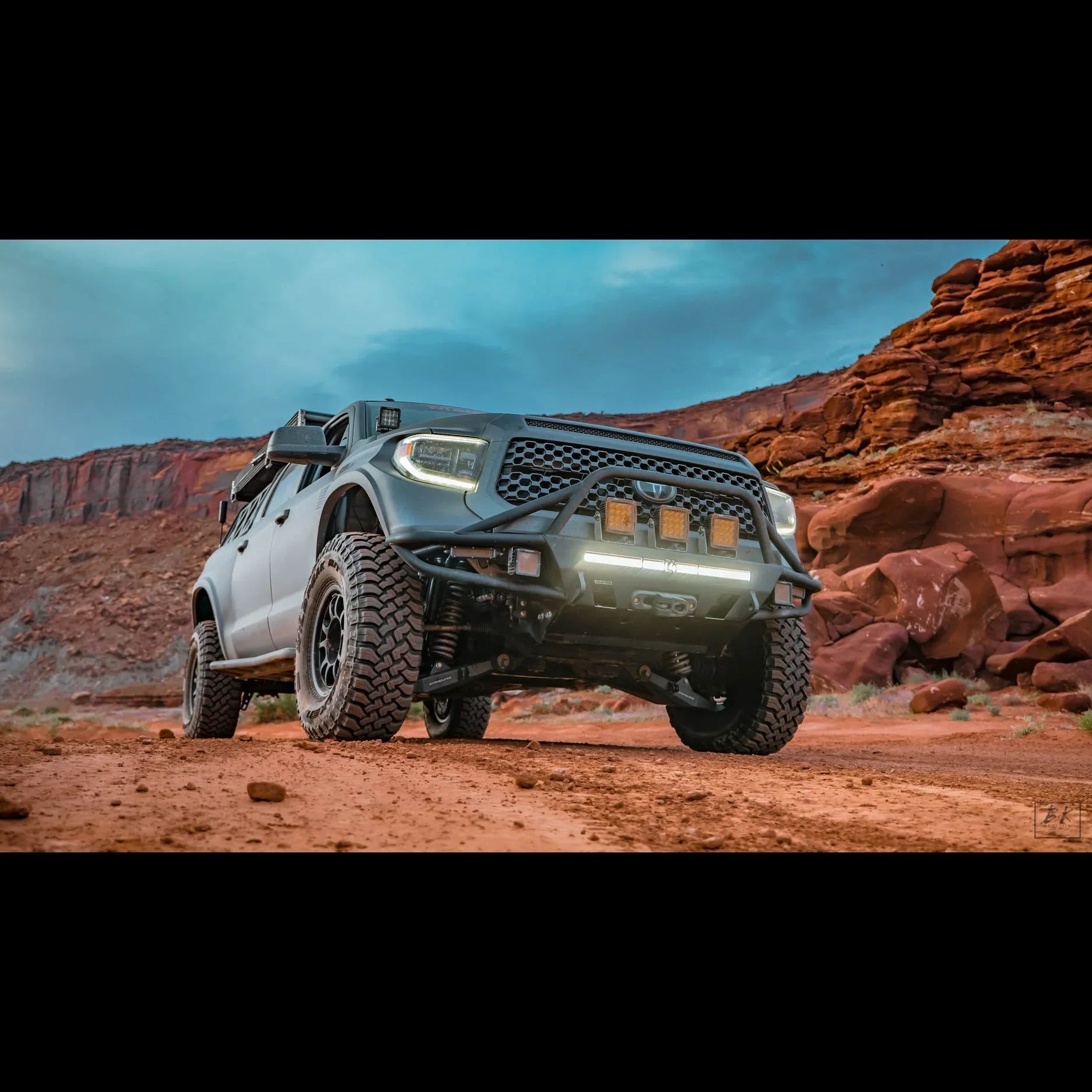 Toyota Tundra off-road truck with rugged accessories on a rocky desert trail