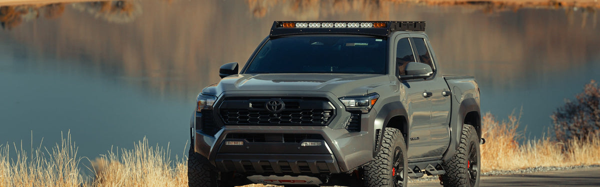 Ford F-150 pickup with LED headlights, fog lights and A-pillar ditch lights on at dusk