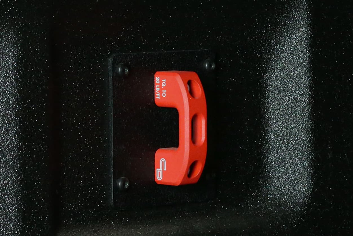 Billet bed tie-down anchor installed in the corner of a Ford F-150 truck bed with a ratchet strap attached