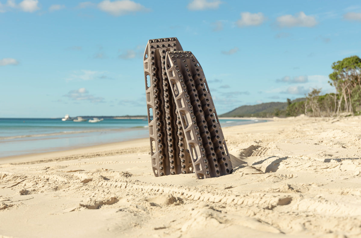 MAXTRAX recovery boards standing in beach sand