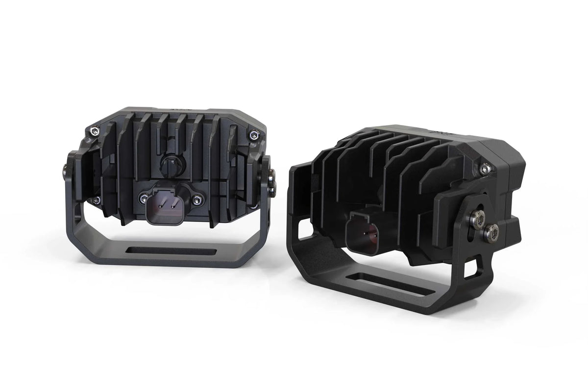 Pair of black off-road LED pod lights with mounting brackets for trucks and SUVs